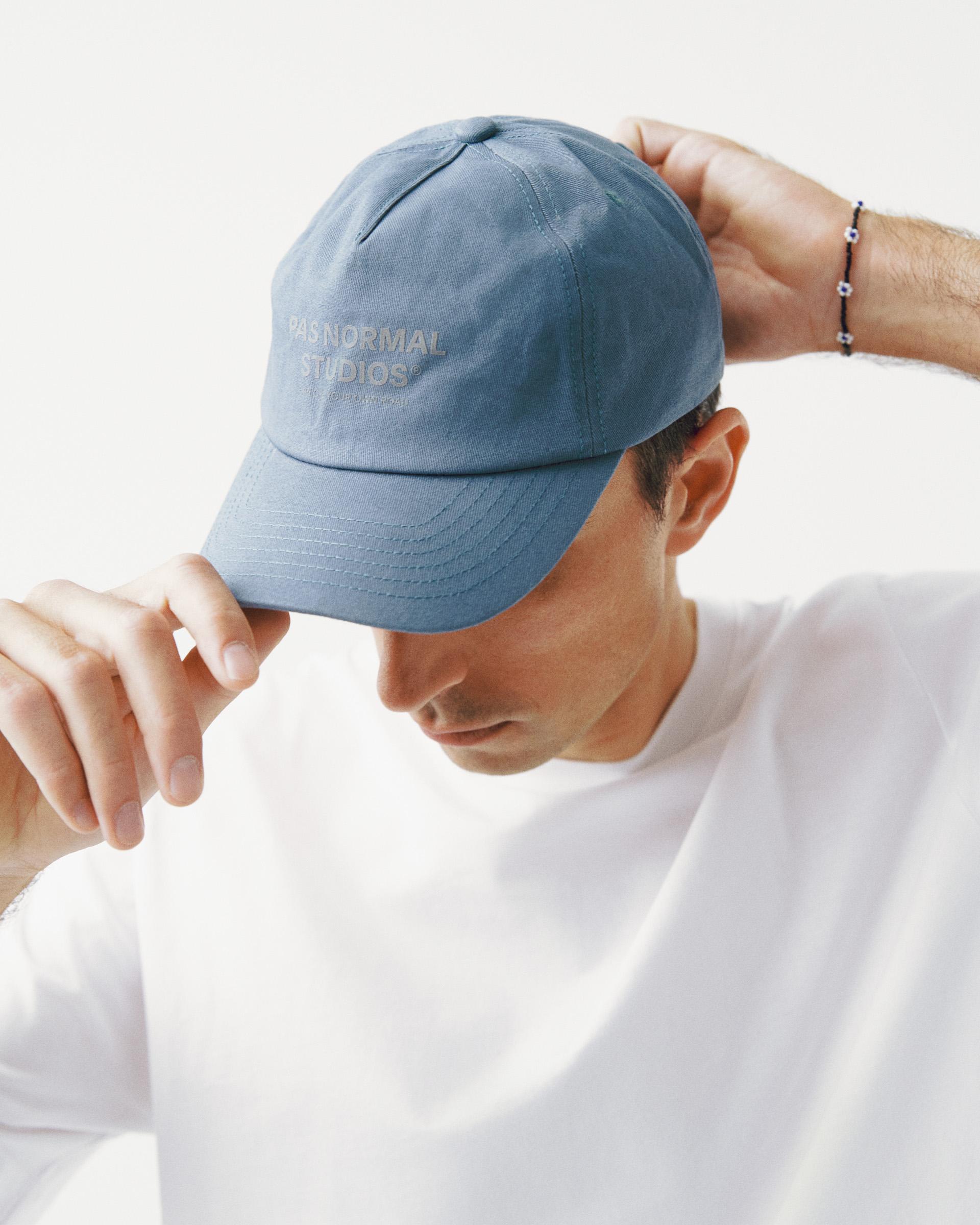 Light Blue Off-Race Cotton cap on model with embossed front logo