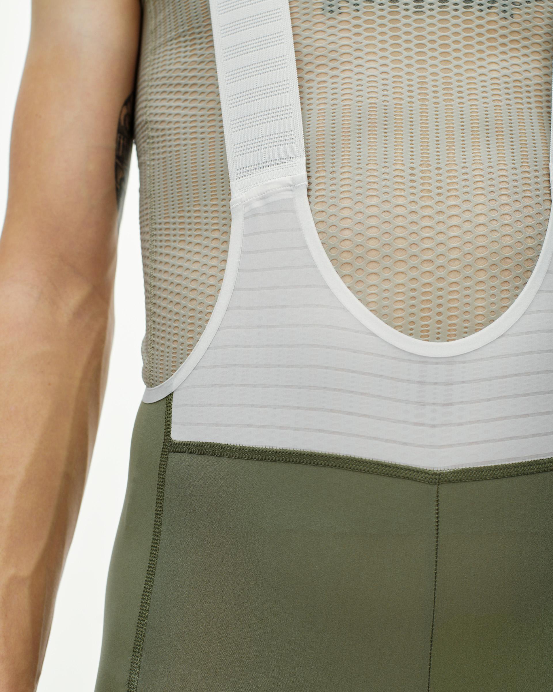 Grey PAS Mechanism Pro bibs on model showing white mesh bib straps and waistband detail