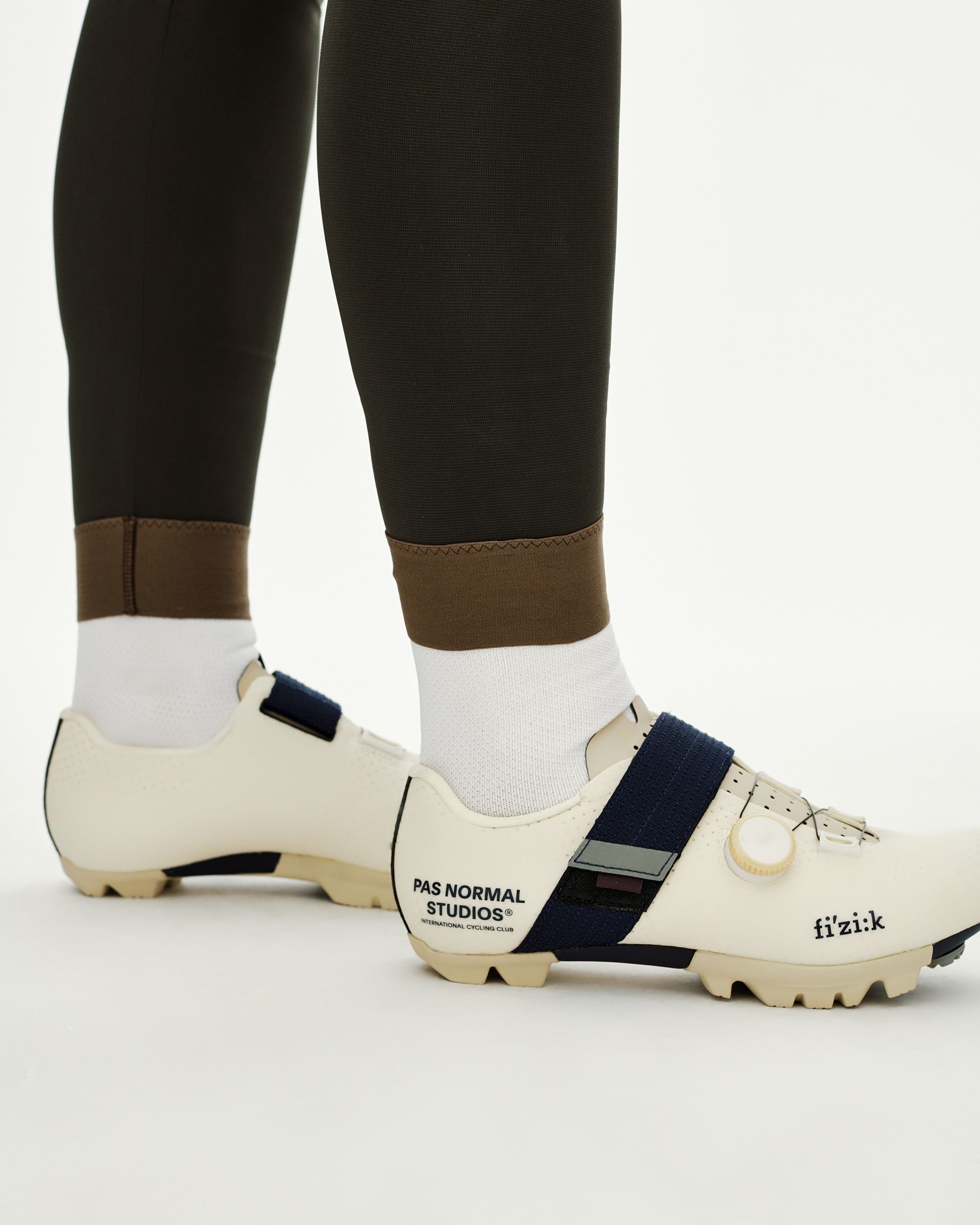Dark Olive Women's Escapism Long Cargo cycling bibs, side detail on model showing contrast brown ankle cuff