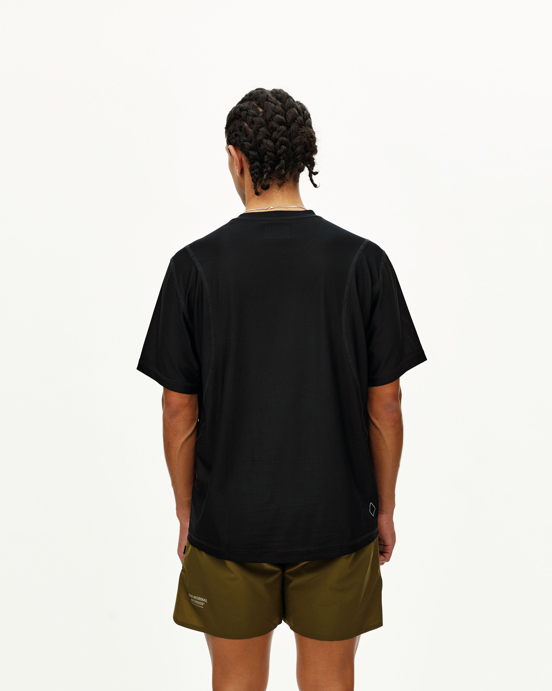 Black Balance T-shirt on model, rear view with small diamond logo patch at hem