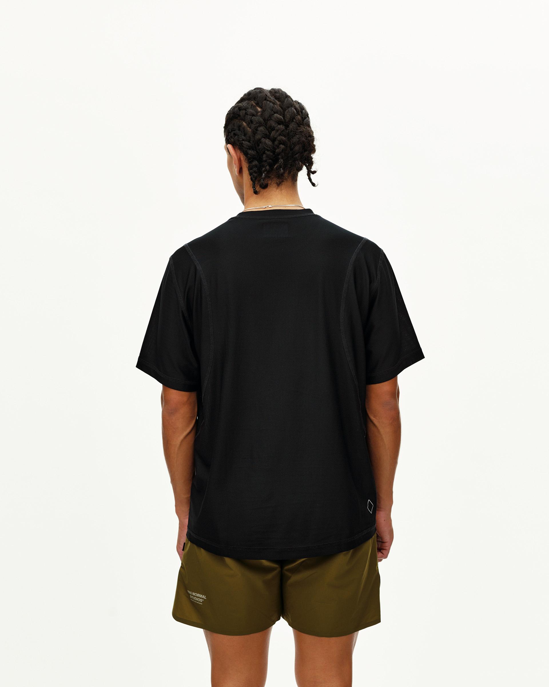 Black Balance T-shirt on model, rear view with small diamond logo patch at hem