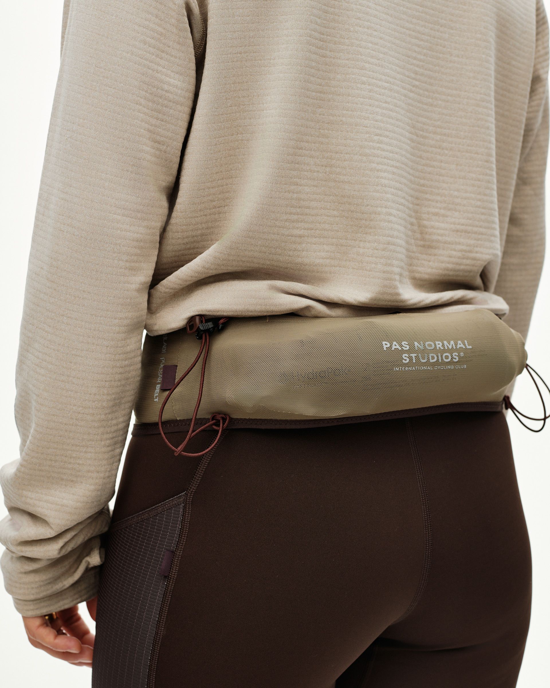 Light Brown Salomon S/LAB Belt worn on model, rear view with mesh panel and contrast cord pulls