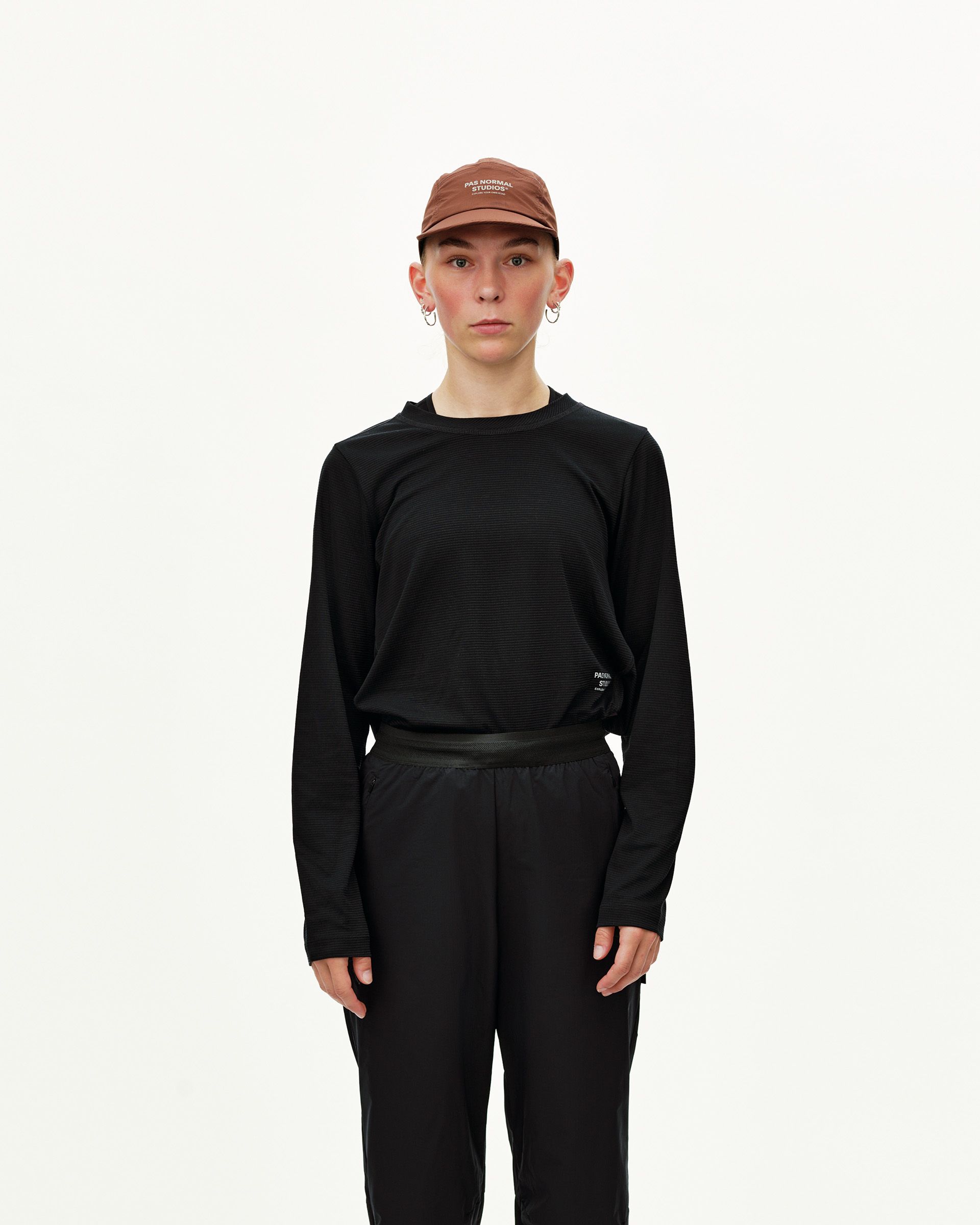 Black Balance Performance pants on model, front view with elasticated waistband and ribbed texture top
