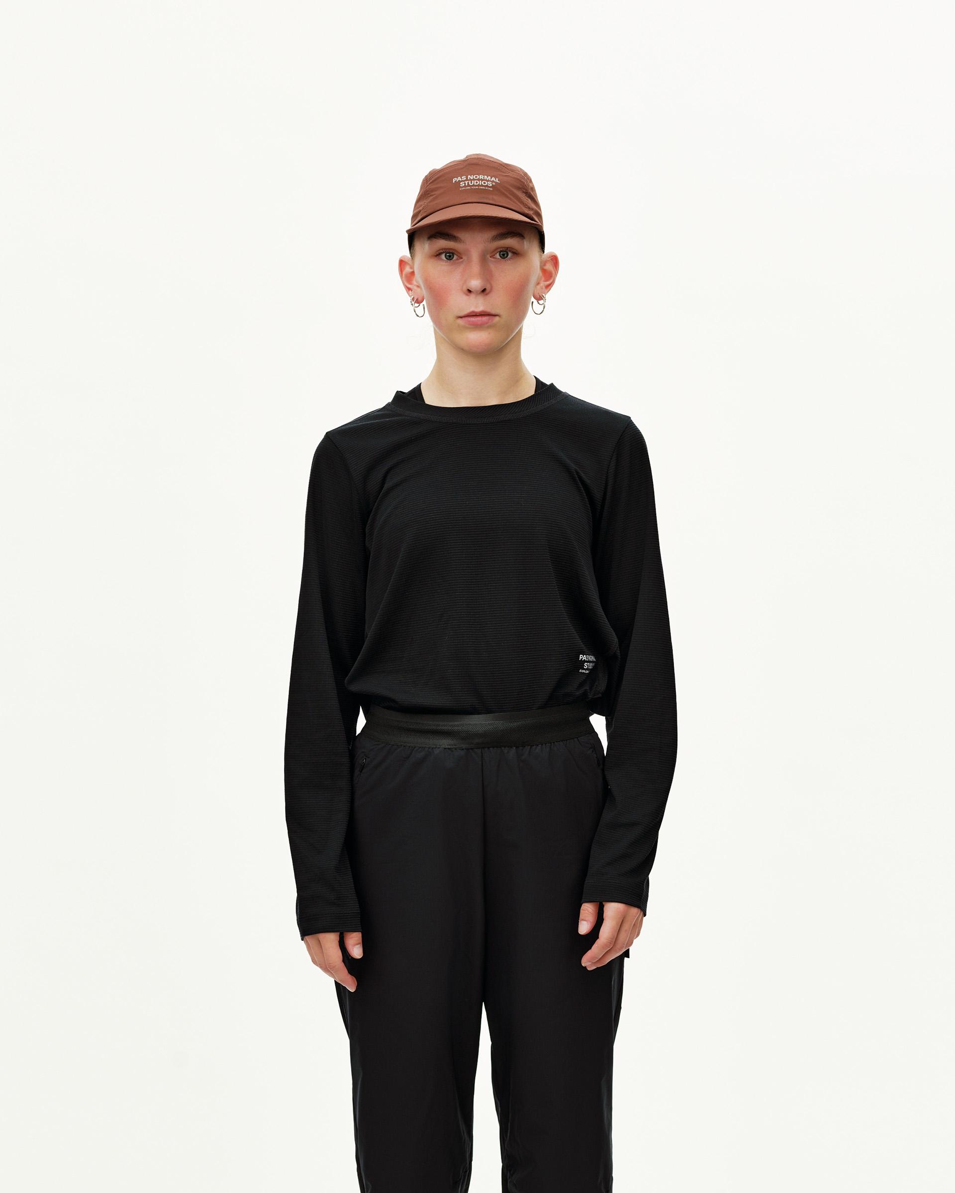 Black Balance Performance pants on model, front view with elasticated waistband and ribbed texture top