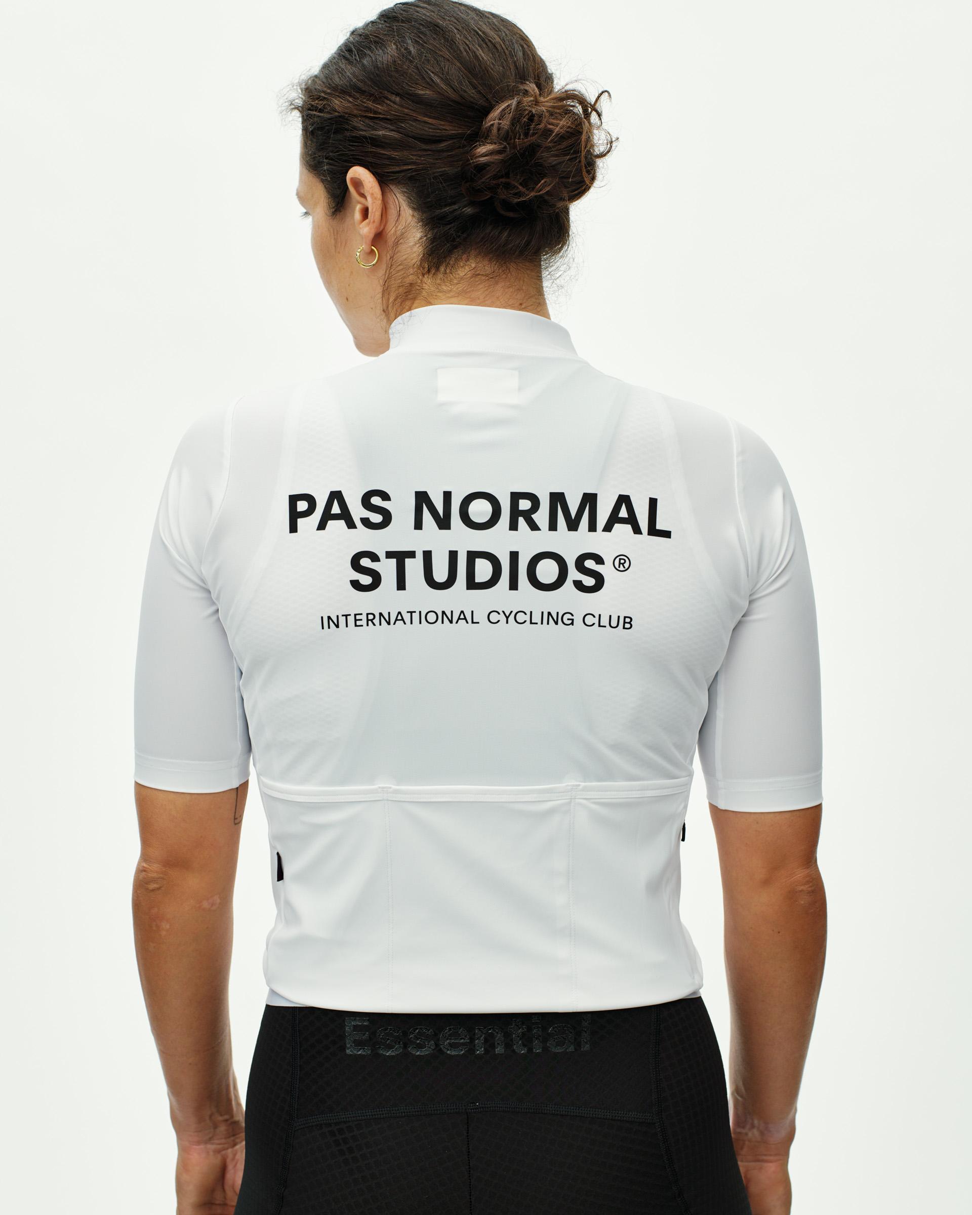 White Essential cycling jersey on model, rear view with large black logo print