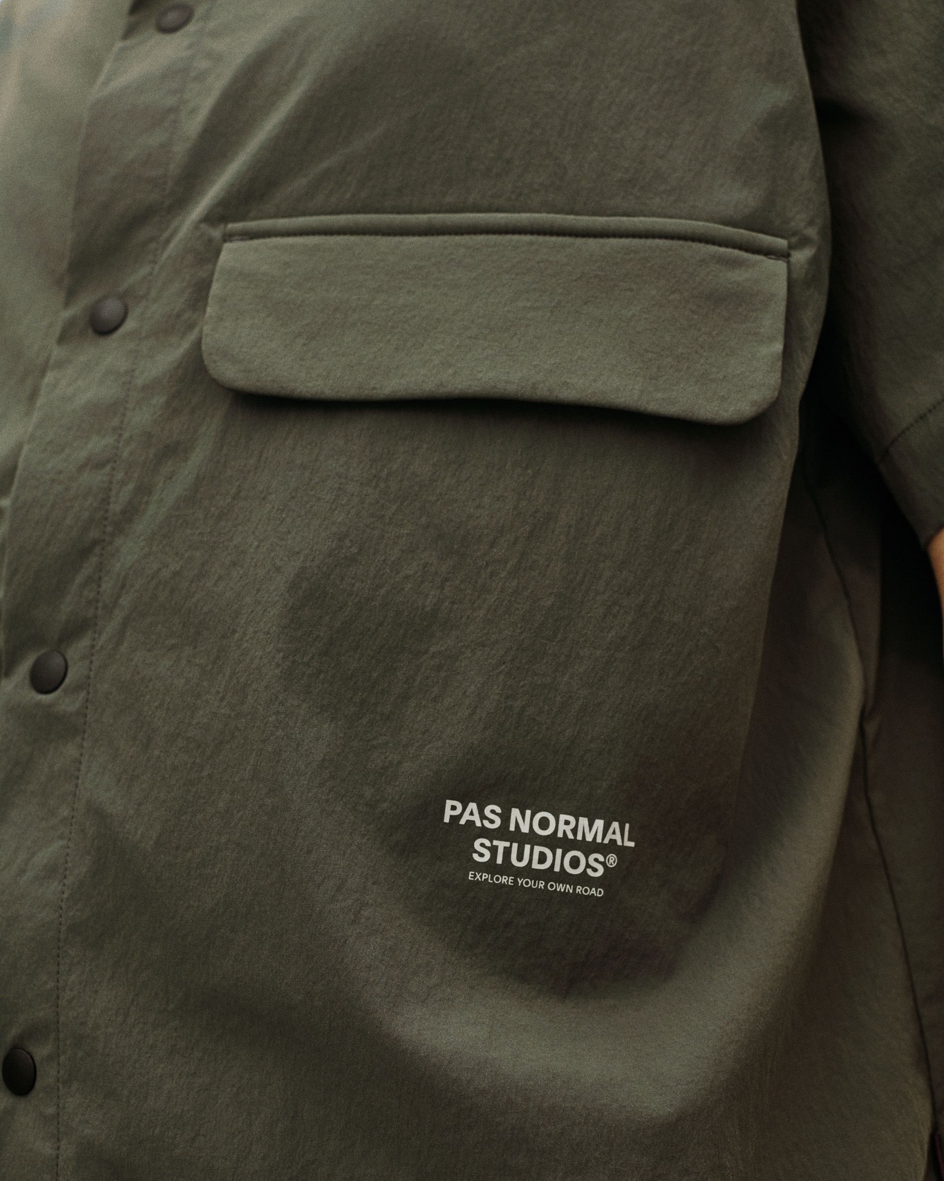 Dark Grey Off-Race Light Tech shirt, detail view showing chest pocket and snap buttons