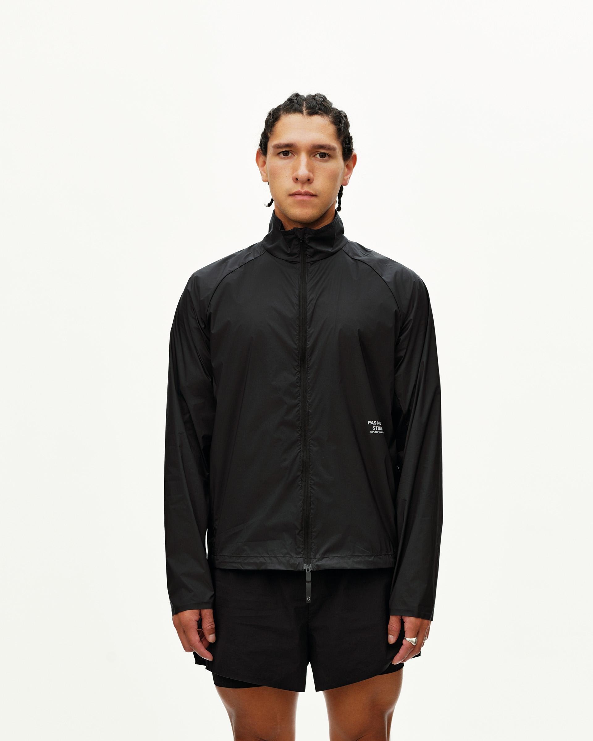 Black Balance Windproof jacket on model, front view with full zip and small chest logo print
