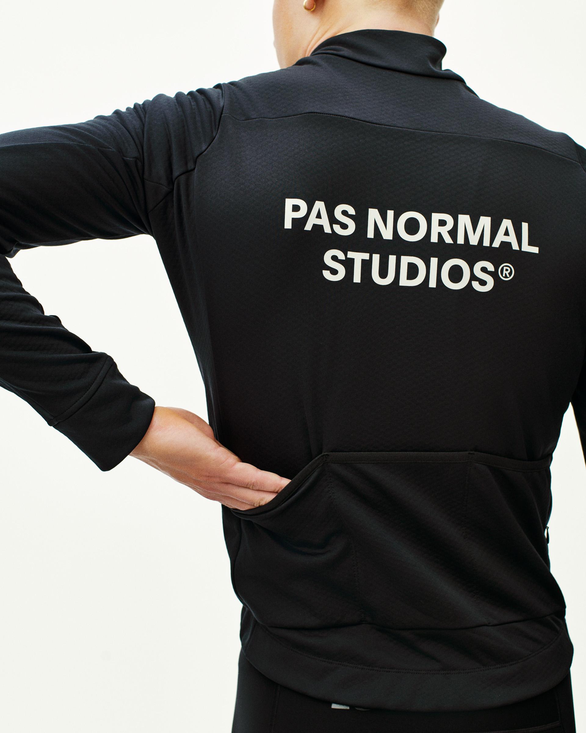 Black Essential thermal long sleeve cycling jersey, rear view on model with white back print