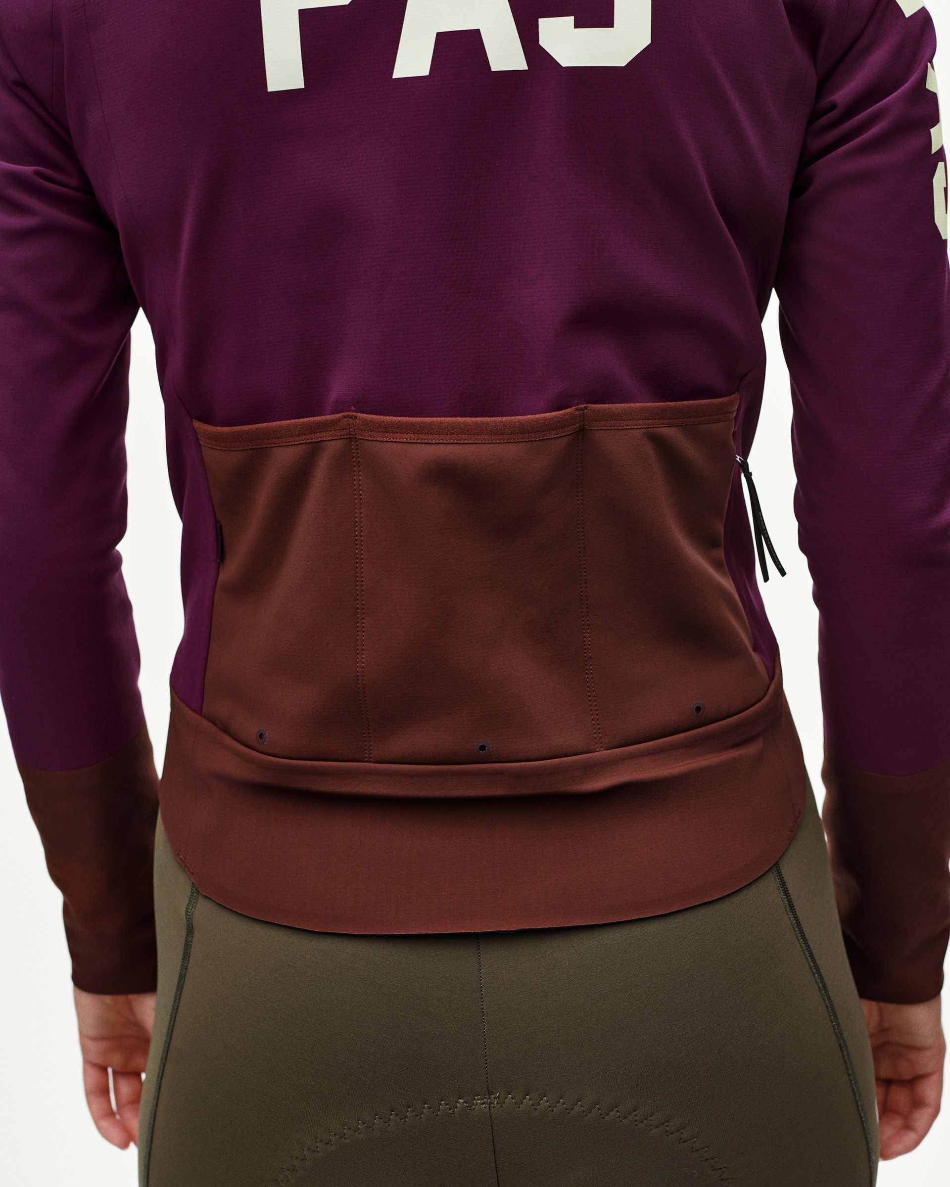 Dark Purple Mechanism women's thermal cycling jacket, rear detail on model showing contrast brown back pocket panel with zip