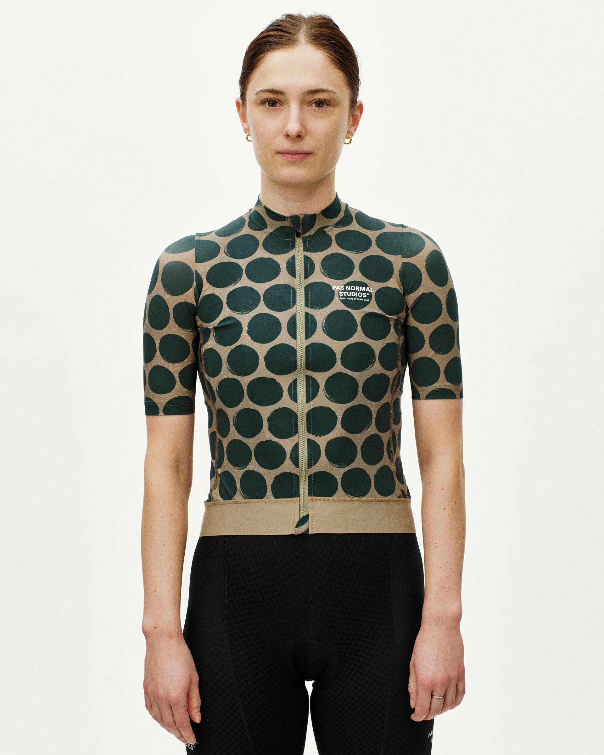 Tan Essential cycling jersey on model with green polka dot pattern and full zip