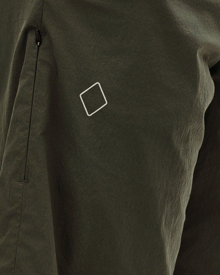 Dark Grey Off-Race Light Tech shorts, detail view showing white logo and side zip pocket