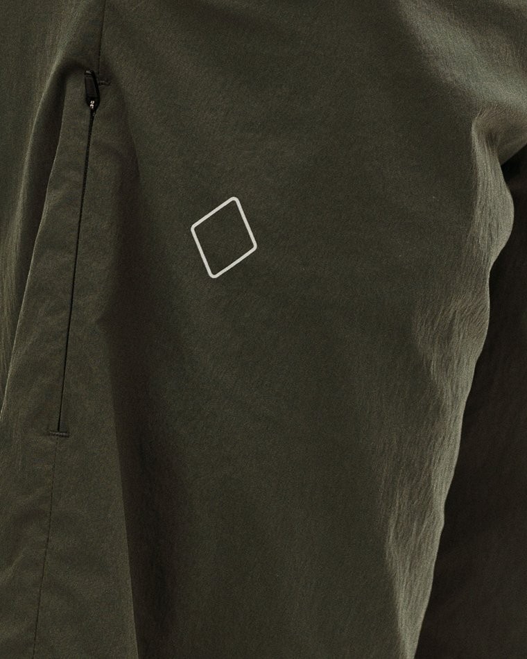 Dark Grey Off-Race Light Tech shorts, detail view showing white logo and side zip pocket