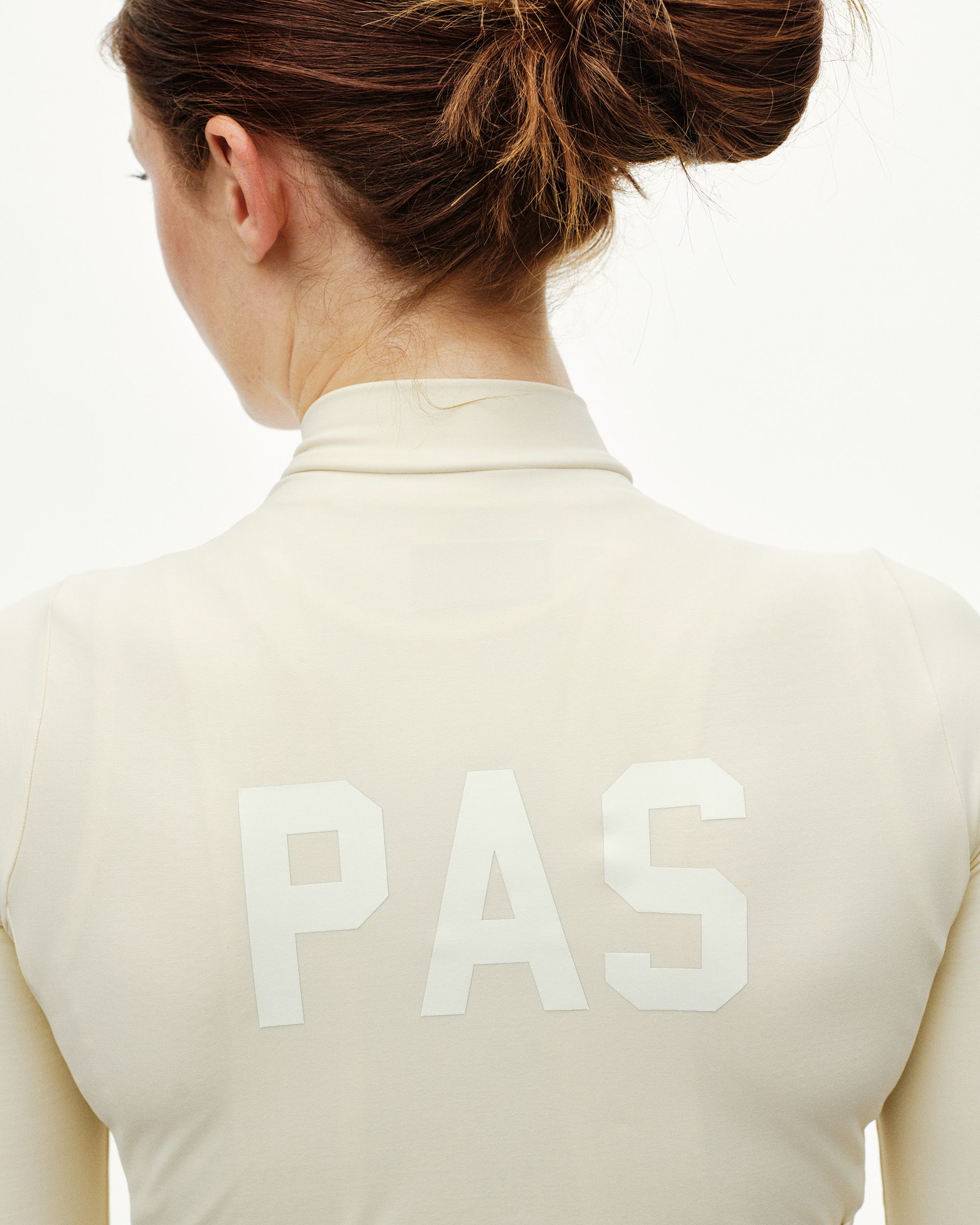 Sand PAS Mechanism women's long sleeve cycling jersey, rear detail on model with white PAS back print