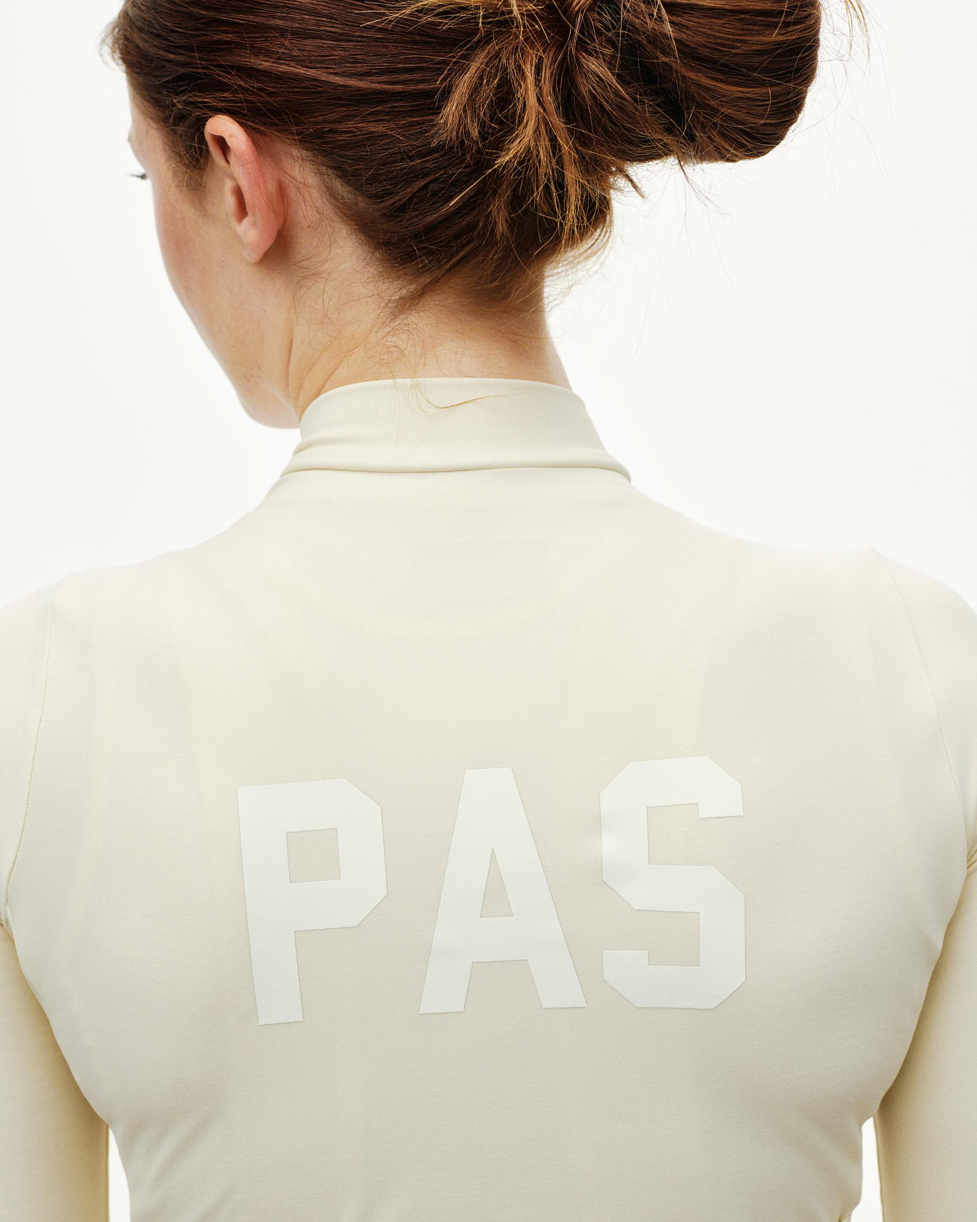 Sand PAS Mechanism women's long sleeve cycling jersey, rear detail on model with white PAS back print