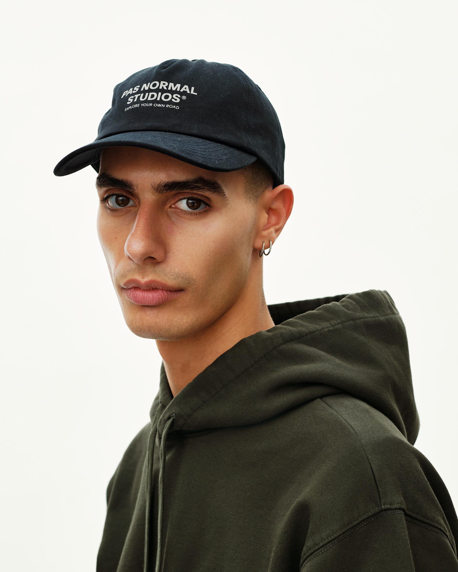 Black Off-Race Cotton cap on model, three-quarter front view with white logo print