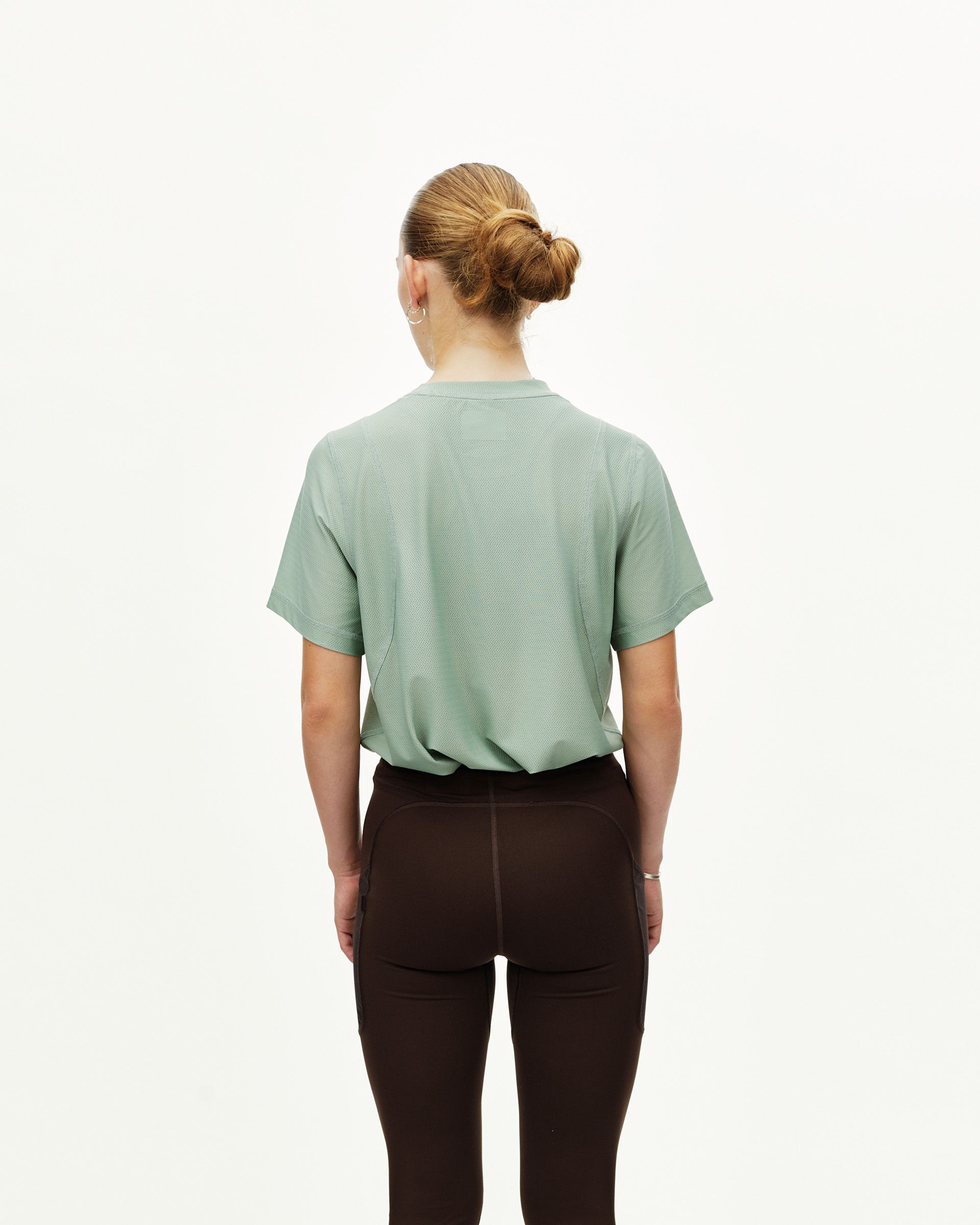 Dark Coffee brown Balance long tights on model, rear view with contrast seam paneling