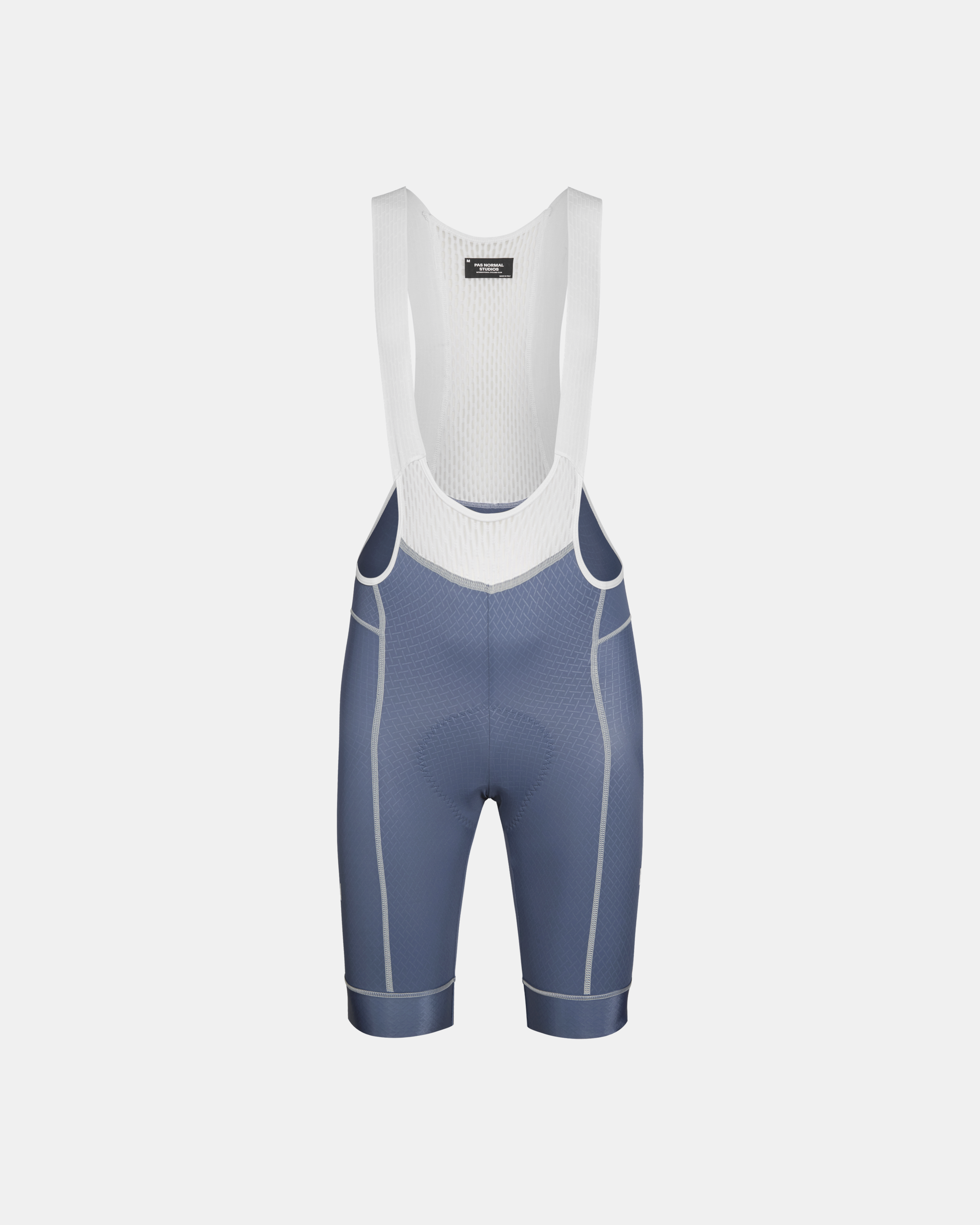 Light Indigo Mechanism cycling bibs, front flat lay with white mesh bib and contrast seam stitching