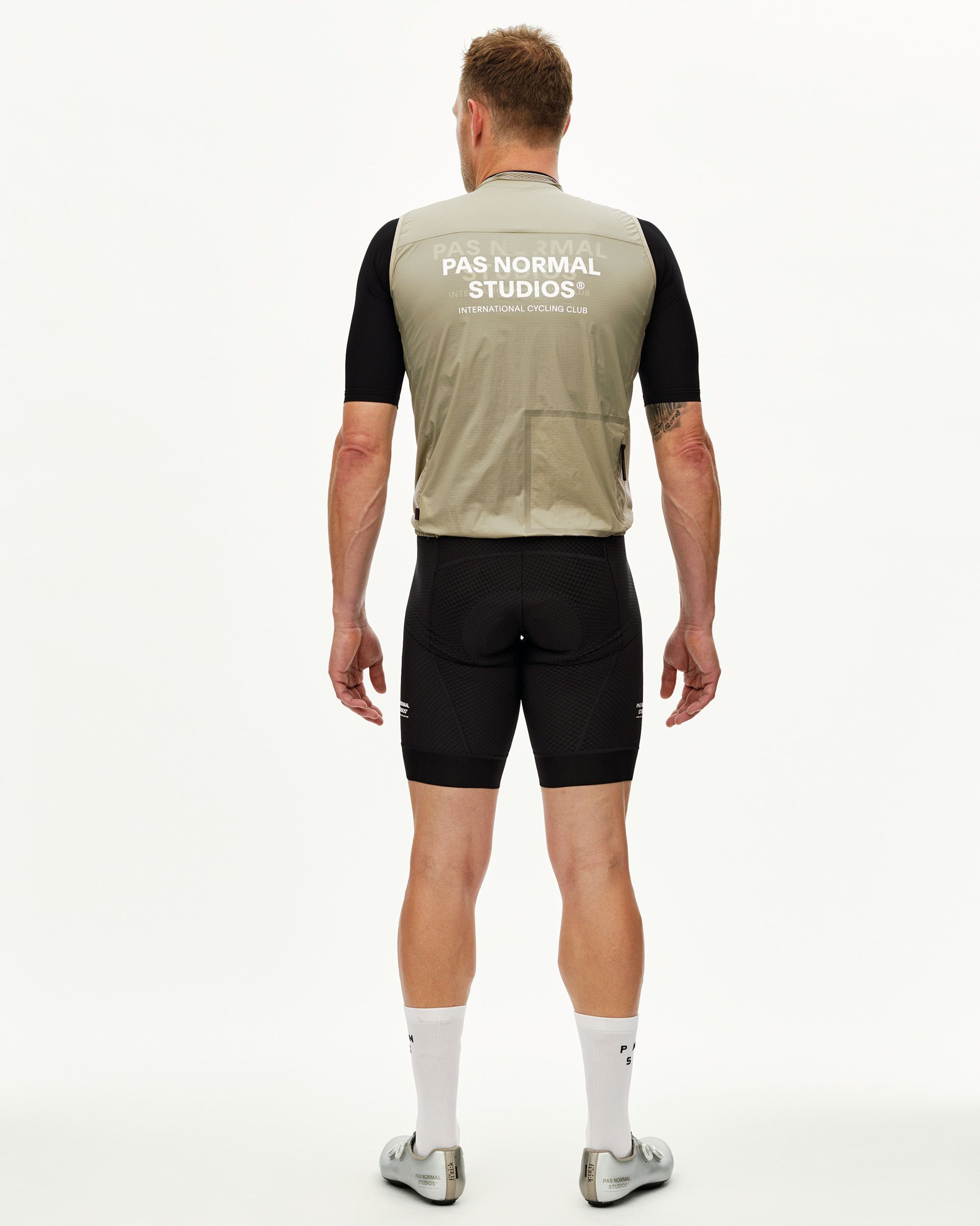 Grey Sage Essential Insulated cycling gilet on model, rear view with white back print
