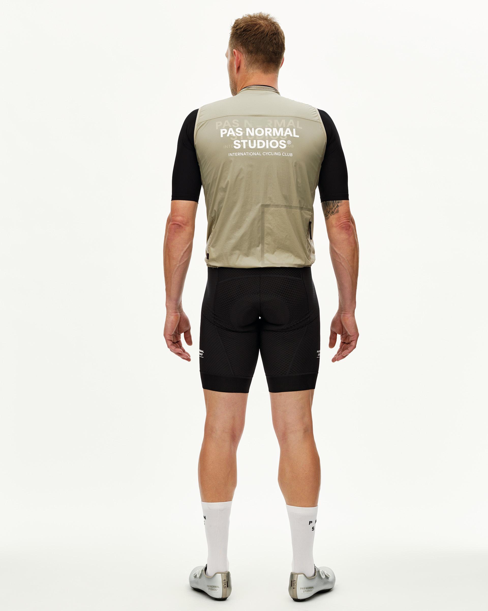 Grey Sage Essential Insulated cycling gilet on model, rear view with white back print