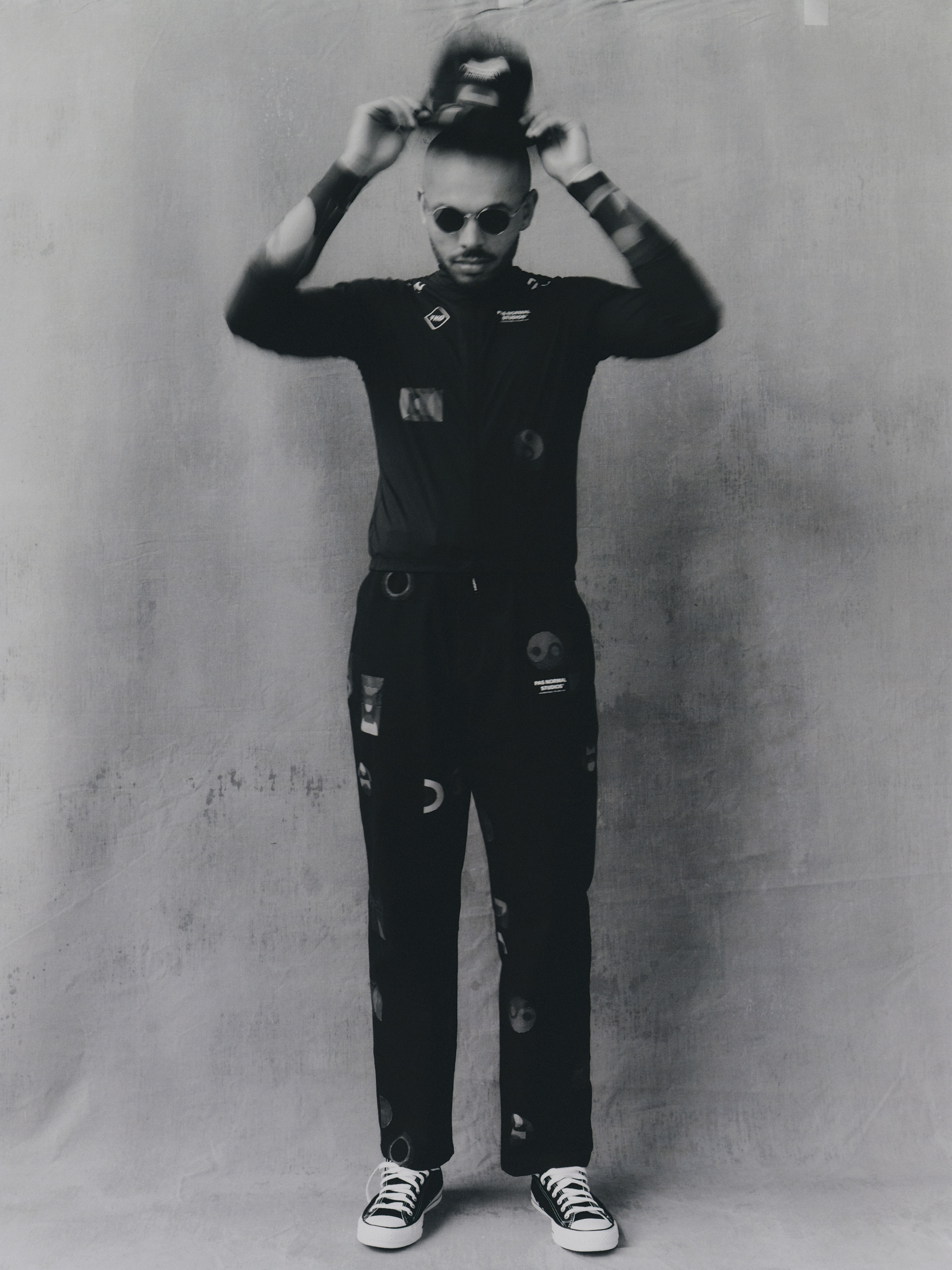 Model wearing black TKO Spring/Summer 2024 collection long sleeve jersey and bib tights with graphic patterns