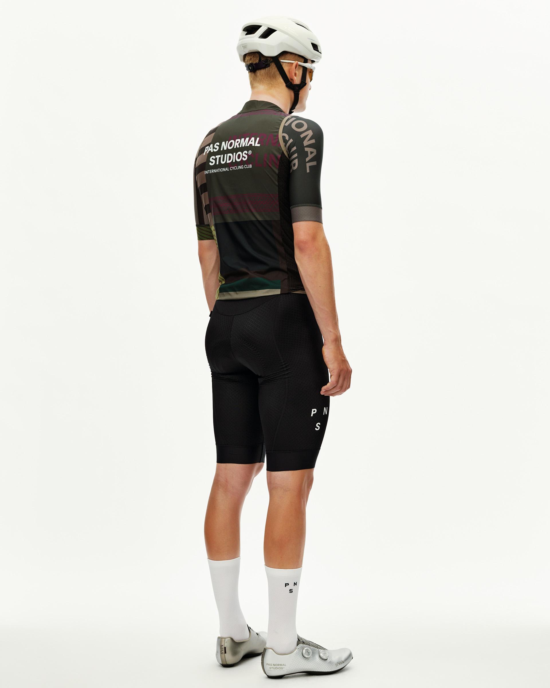 International Earth khaki Mechanism Stow Away cycling gilet on model, rear view with multicolour graphic print