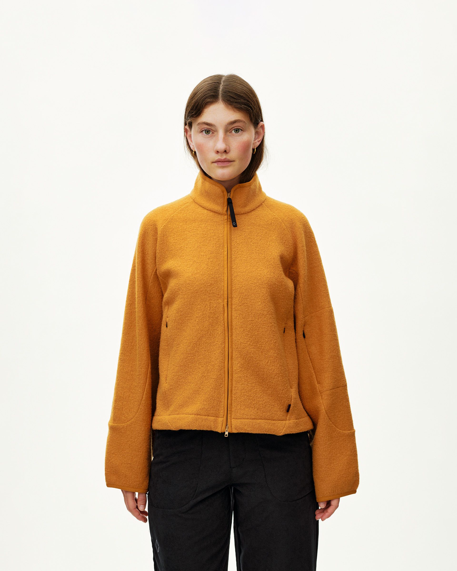 Ochre Off-Race Boiled Wool jacket on model, front view with full zip and mock neck