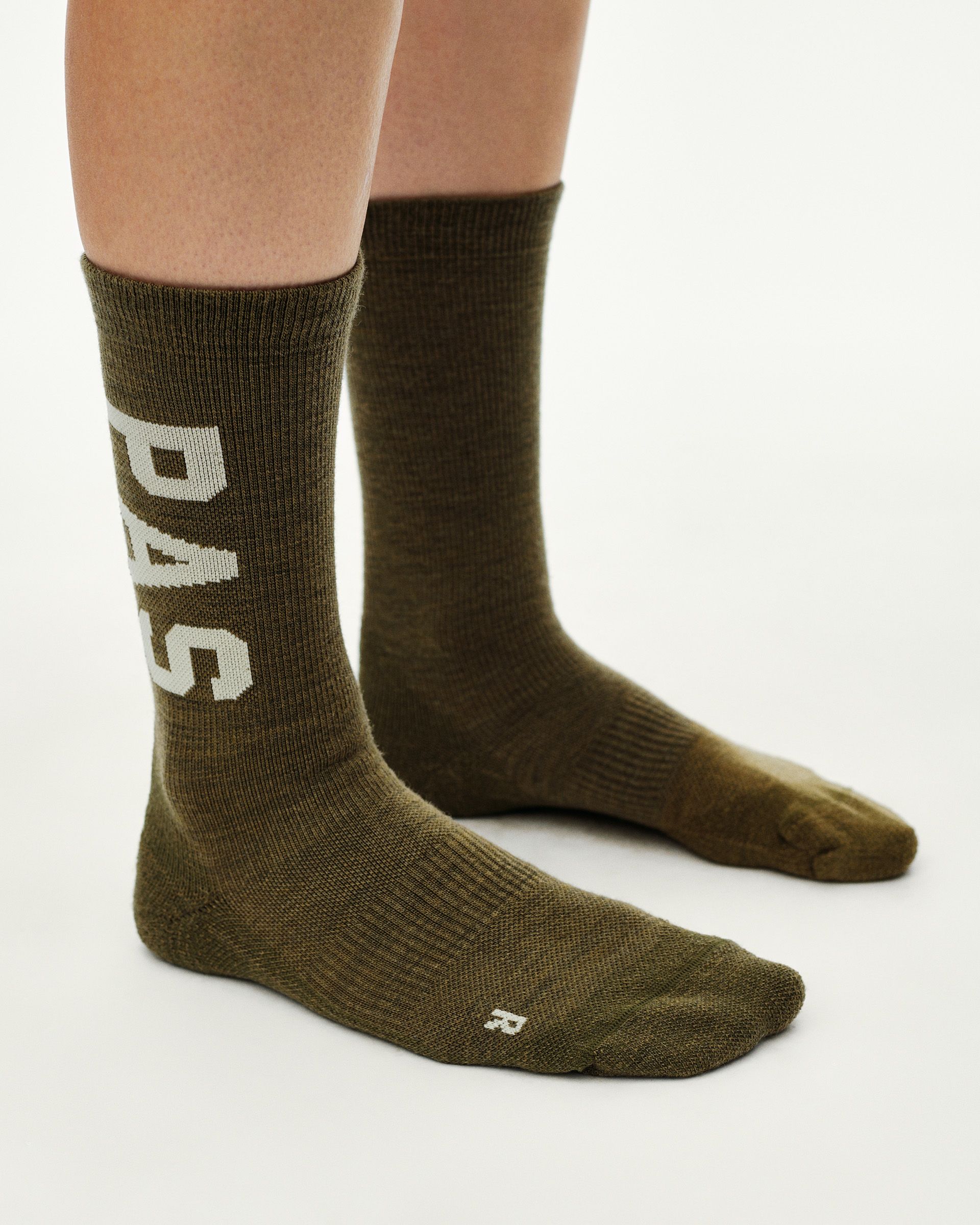 Moss Brown PAS Thermal Wool cycling socks on model, side view with cream large logo lettering on calf