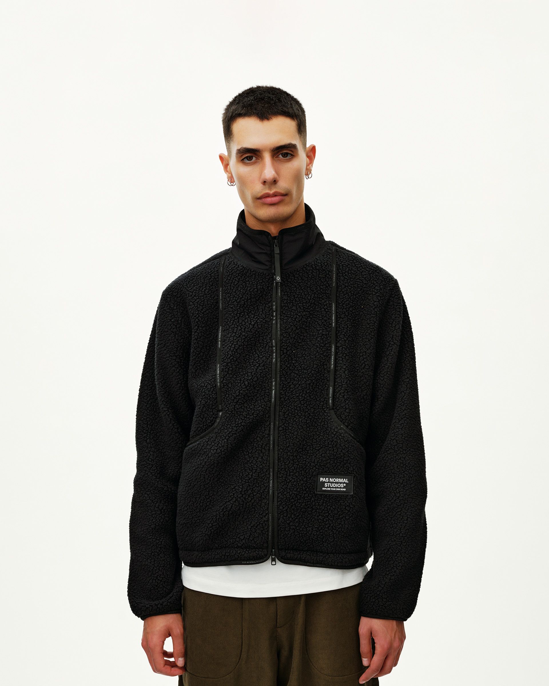 Black Off-Race Pile Fleece jacket on model, front view with full zip and branded patch at hem