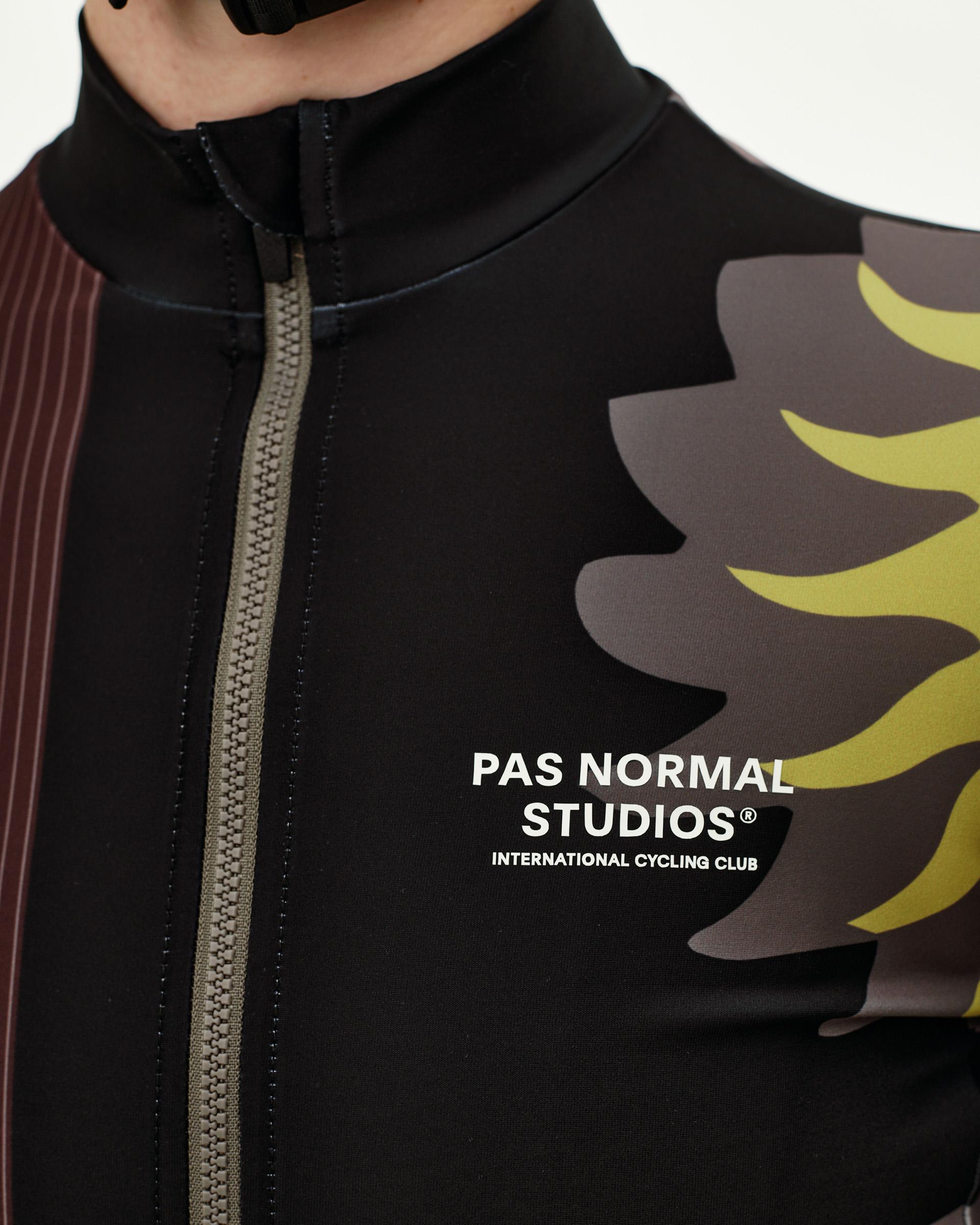 Dark Olive Mechanism women's long sleeve cycling jersey, front detail on model with flame graphic and contrast zip
