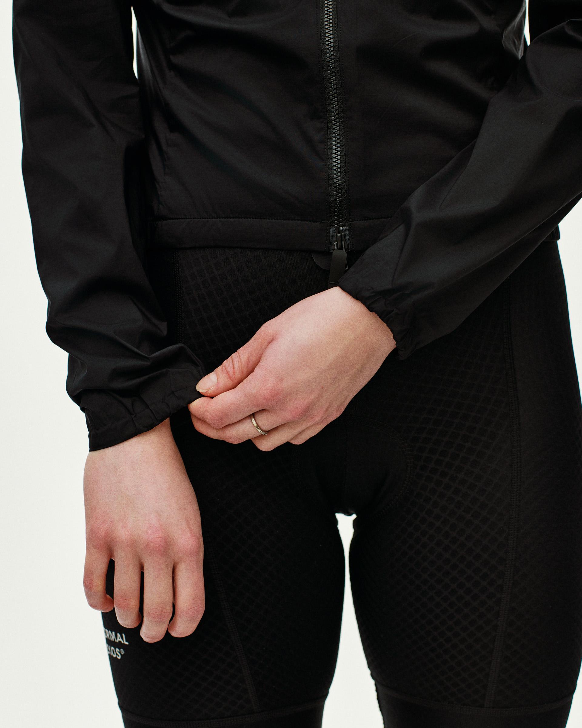 Black Essential Insulated cycling jacket on model, front view with full zip and elastic waistband