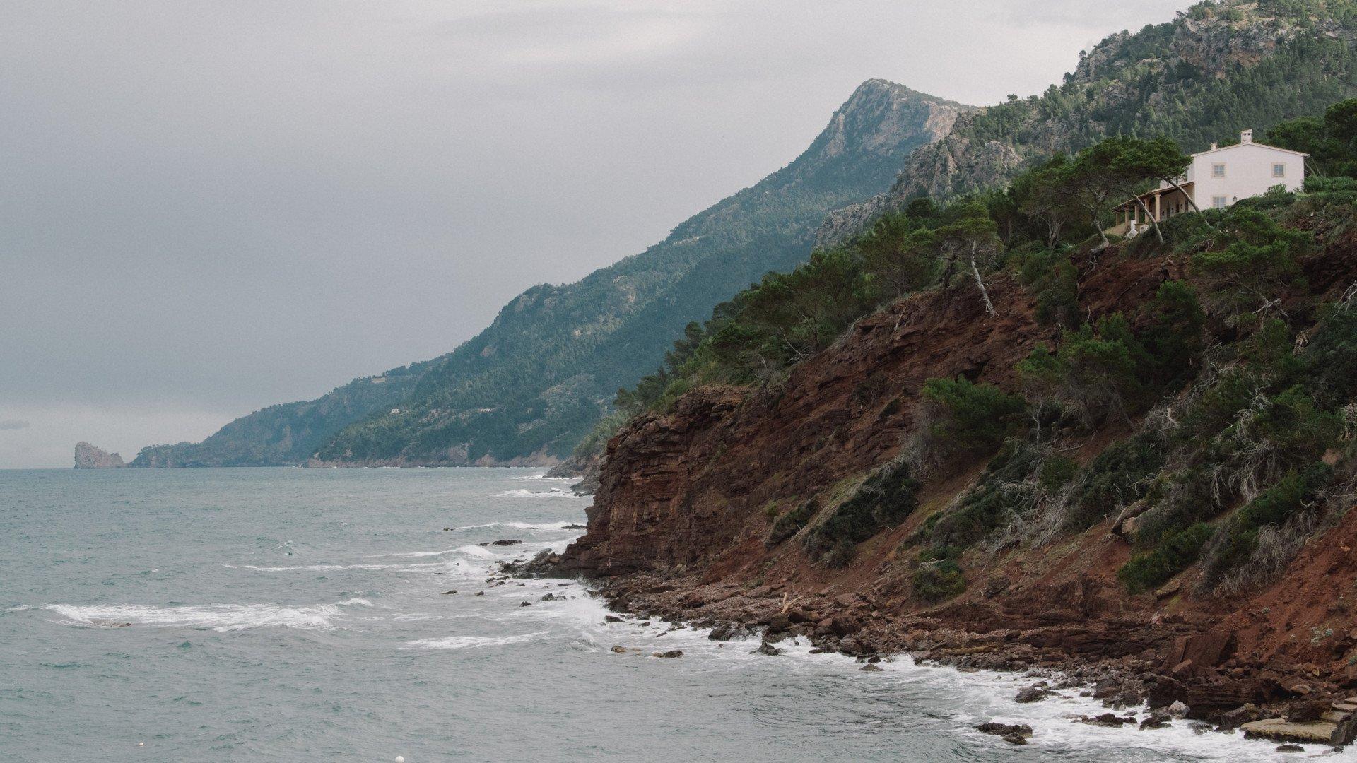 Coastal landscape with rocky cliffs, mountains, and Mediterranean coastline