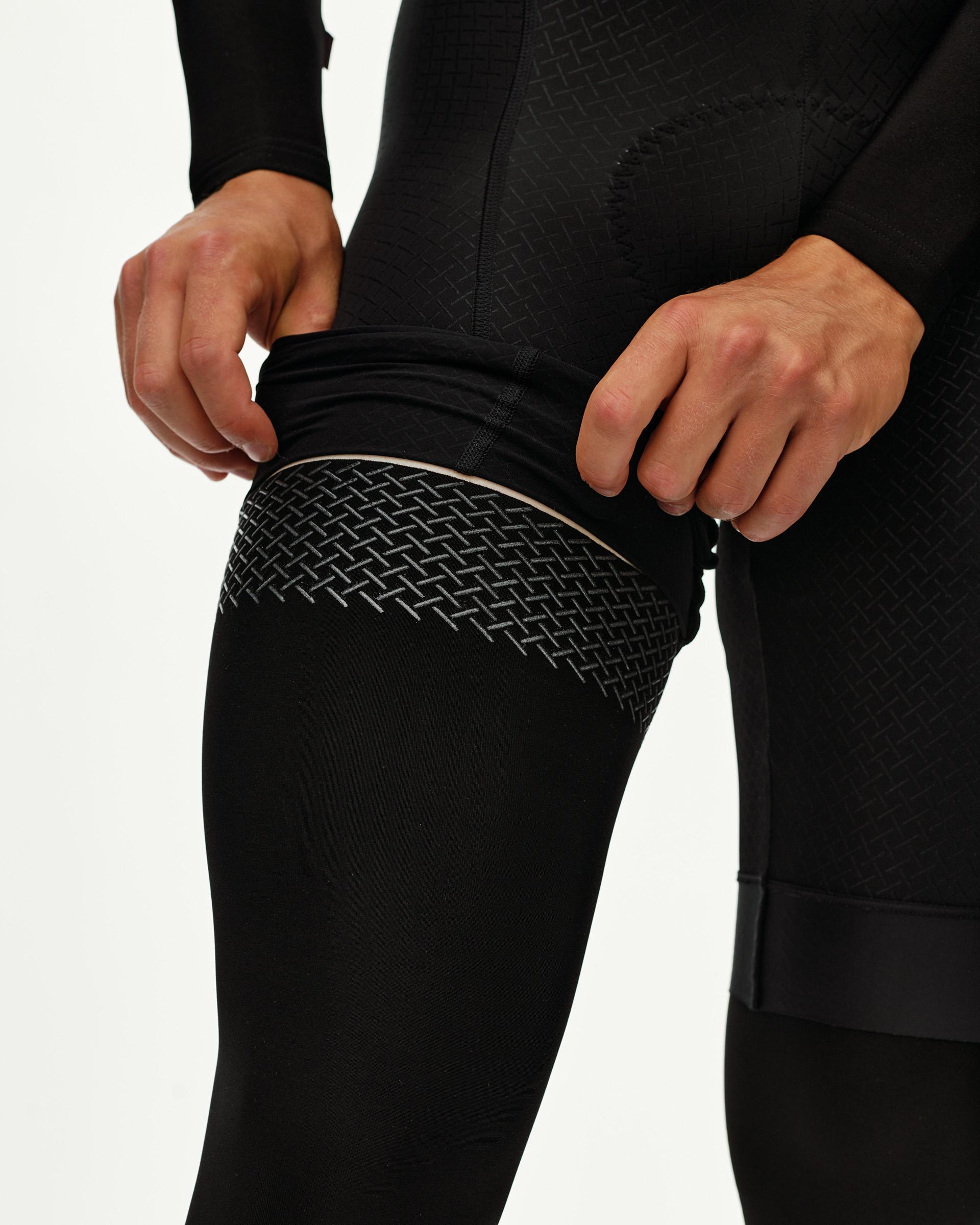 Black Logo leg warmers, detail view on model showing textured herringbone gripper band
