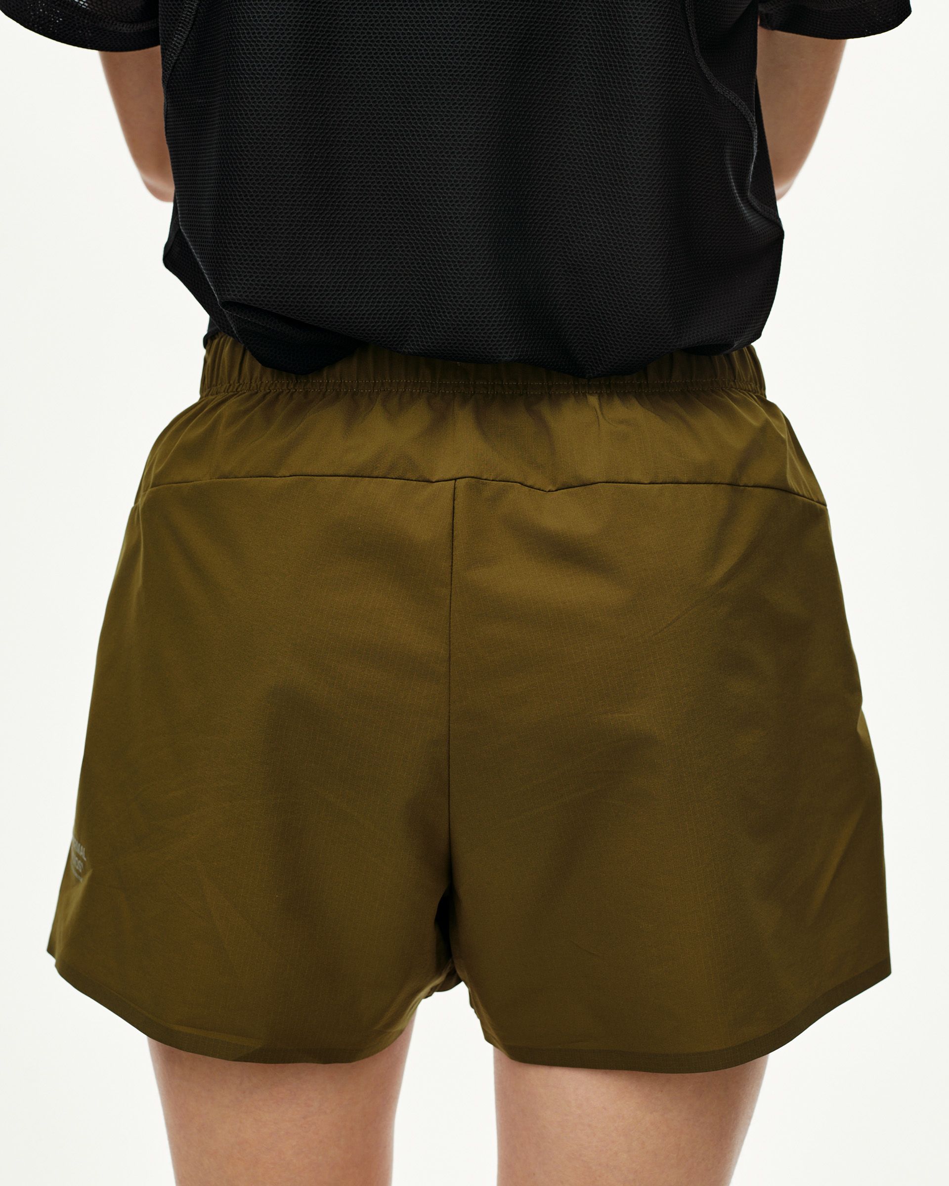 Moss Brown Balance women's shorts, rear view on model with elastic waistband