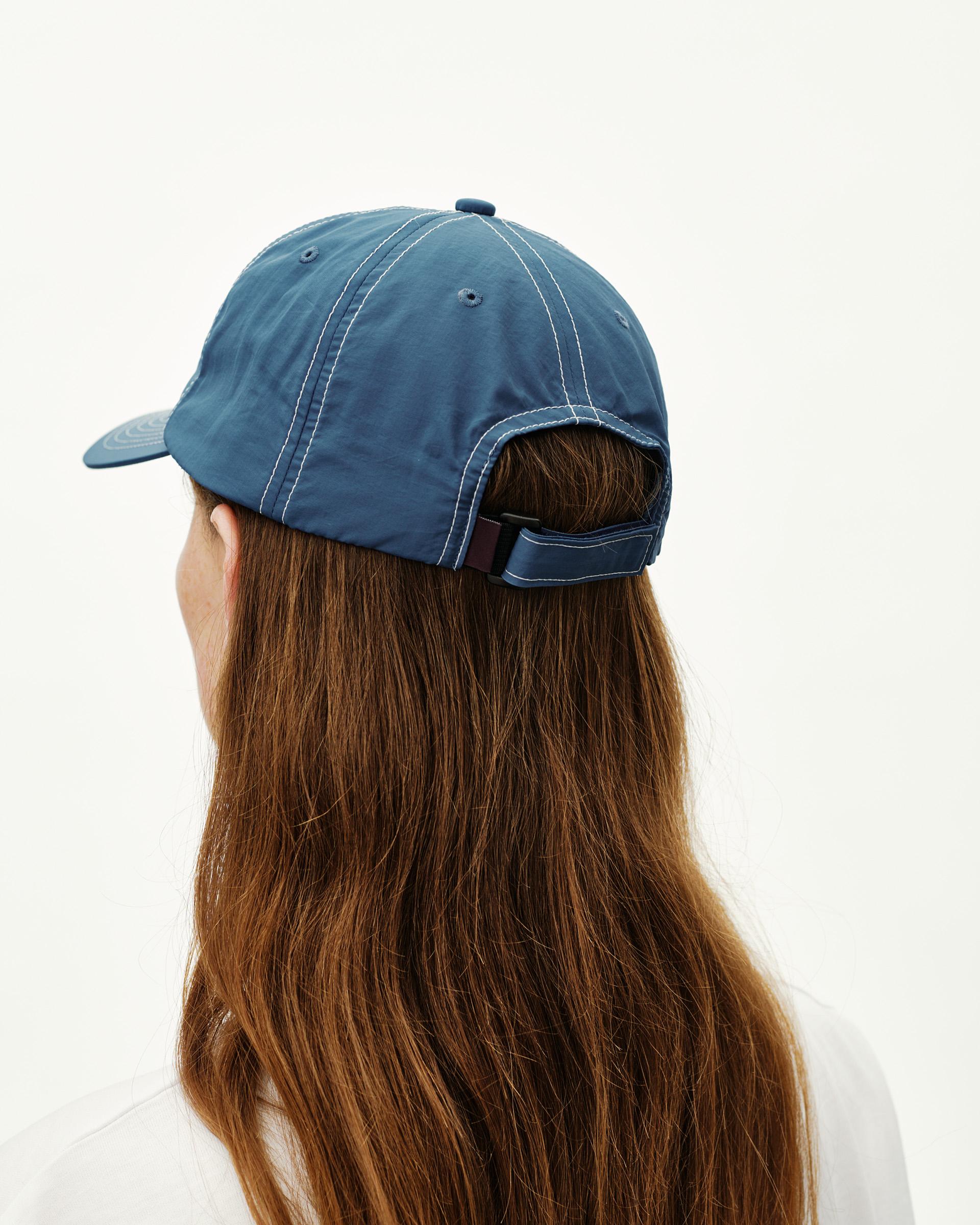 Ocean Blue Off-Race cap on model, rear view with contrast stitching and adjustable back strap