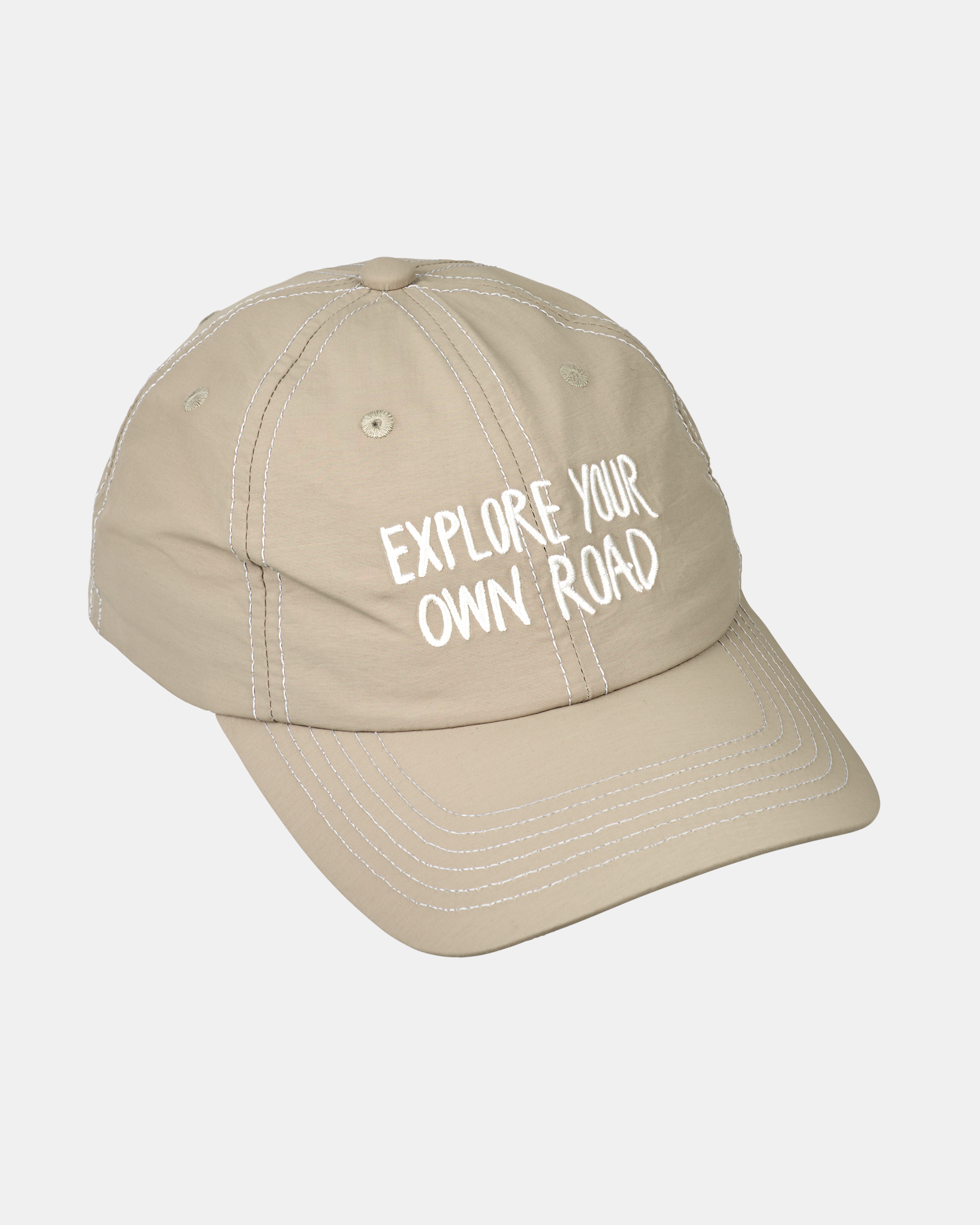 Beige Off-Race cap, angled view with white "Explore Your Own Road" text