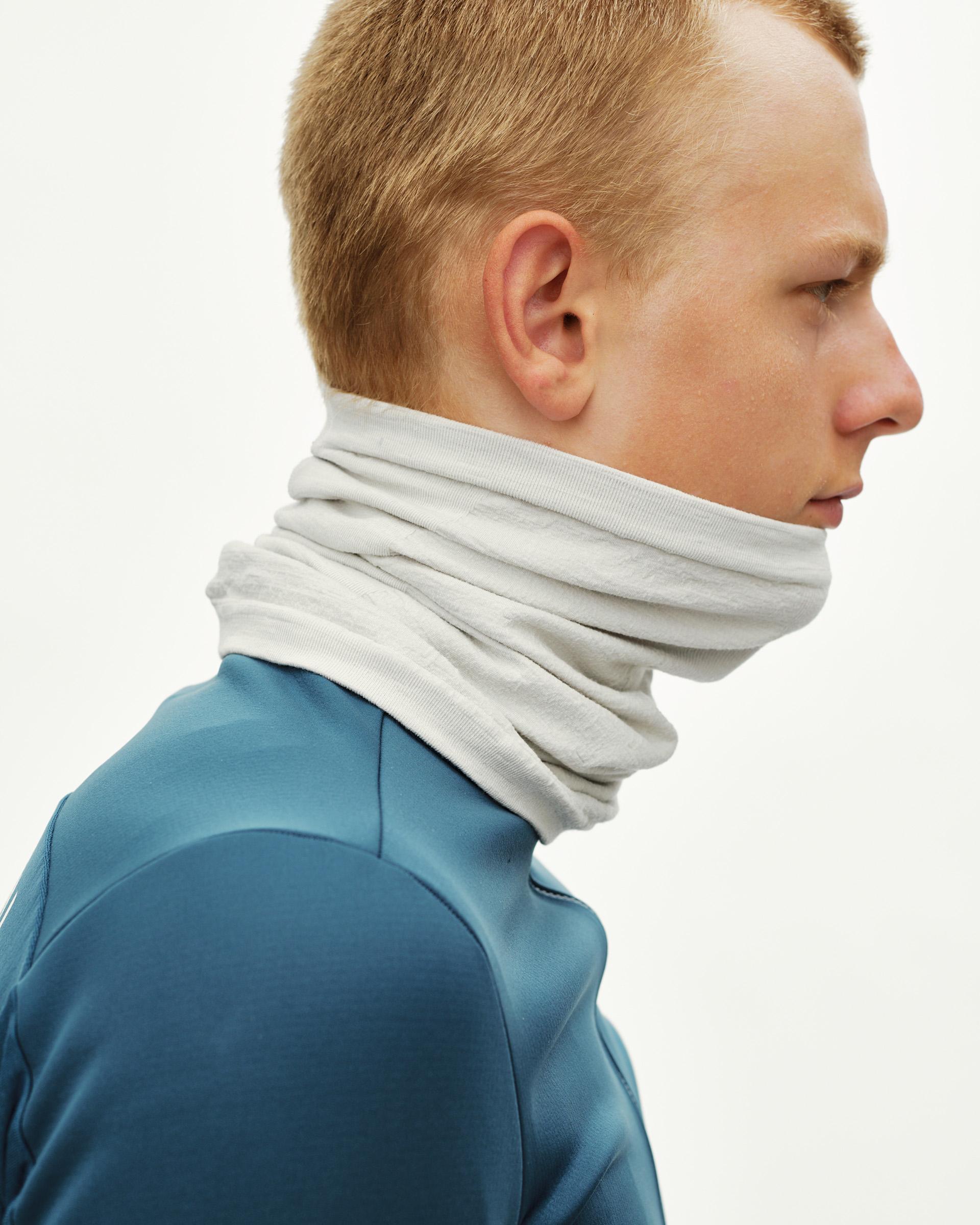 Misty Grey Essential Logo Merino Knit necktube on model, side view worn around neck and chin