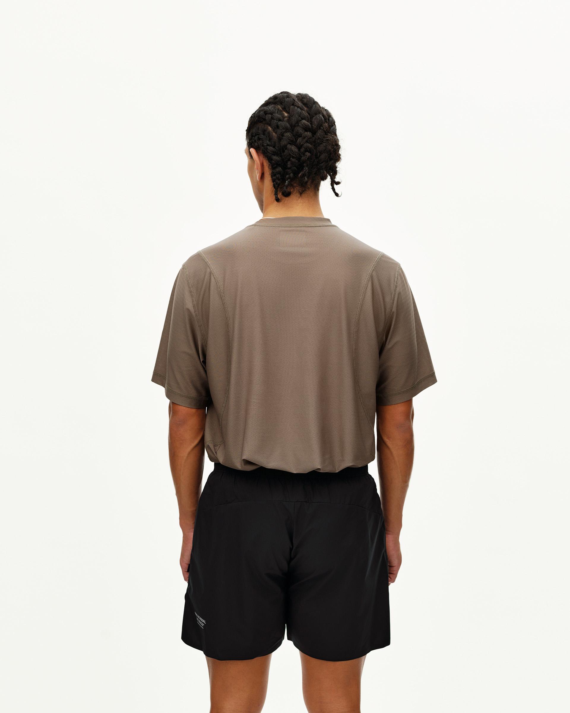 Black Balance shorts on model, rear view with elastic waistband and side pockets