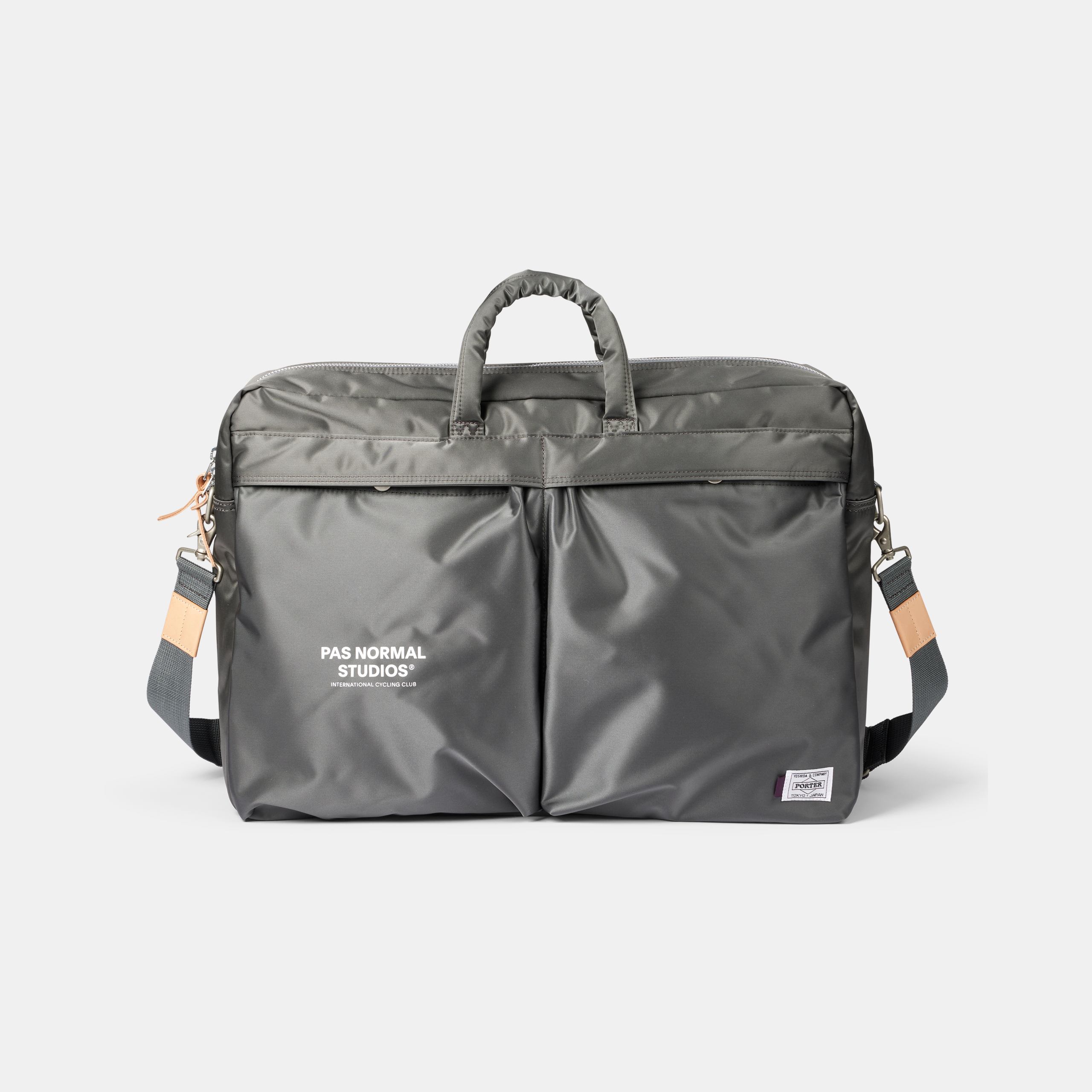 Grey Porter-Yoshida 2-Way briefcase, front view with shoulder strap and tan leather accents
