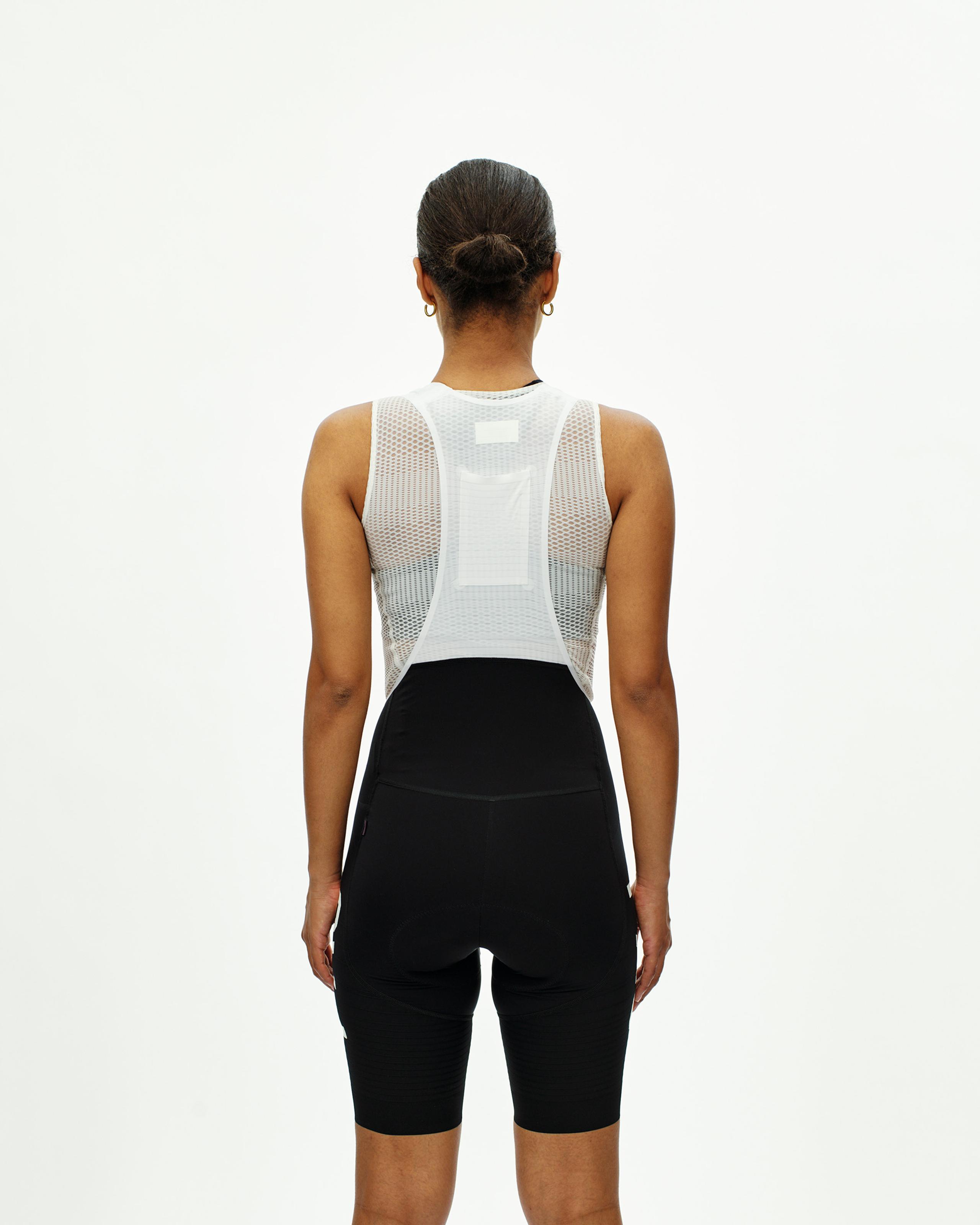 Black PAS Mechanism Pro bibs on model, rear view showing white mesh base layer