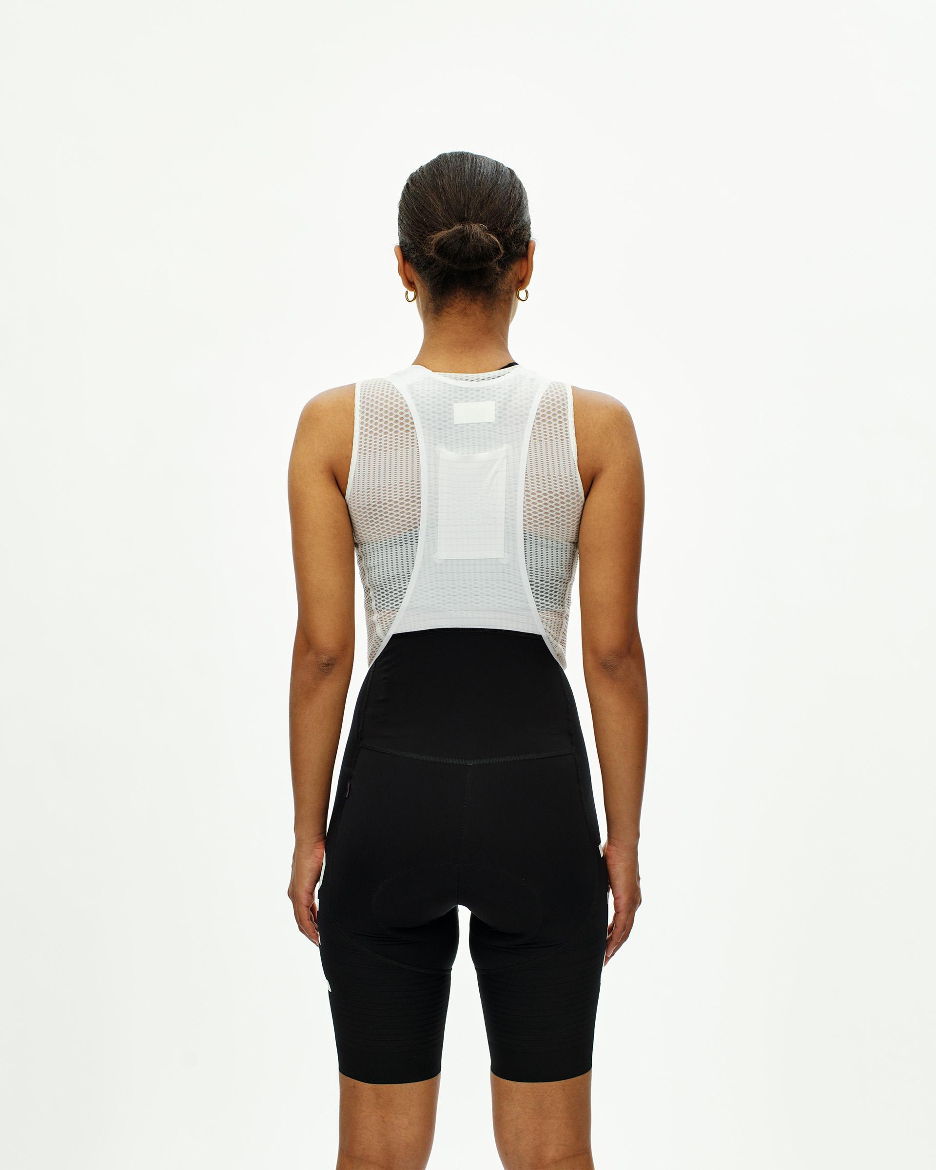 Black PAS Mechanism Pro bibs on model, rear view showing white mesh base layer