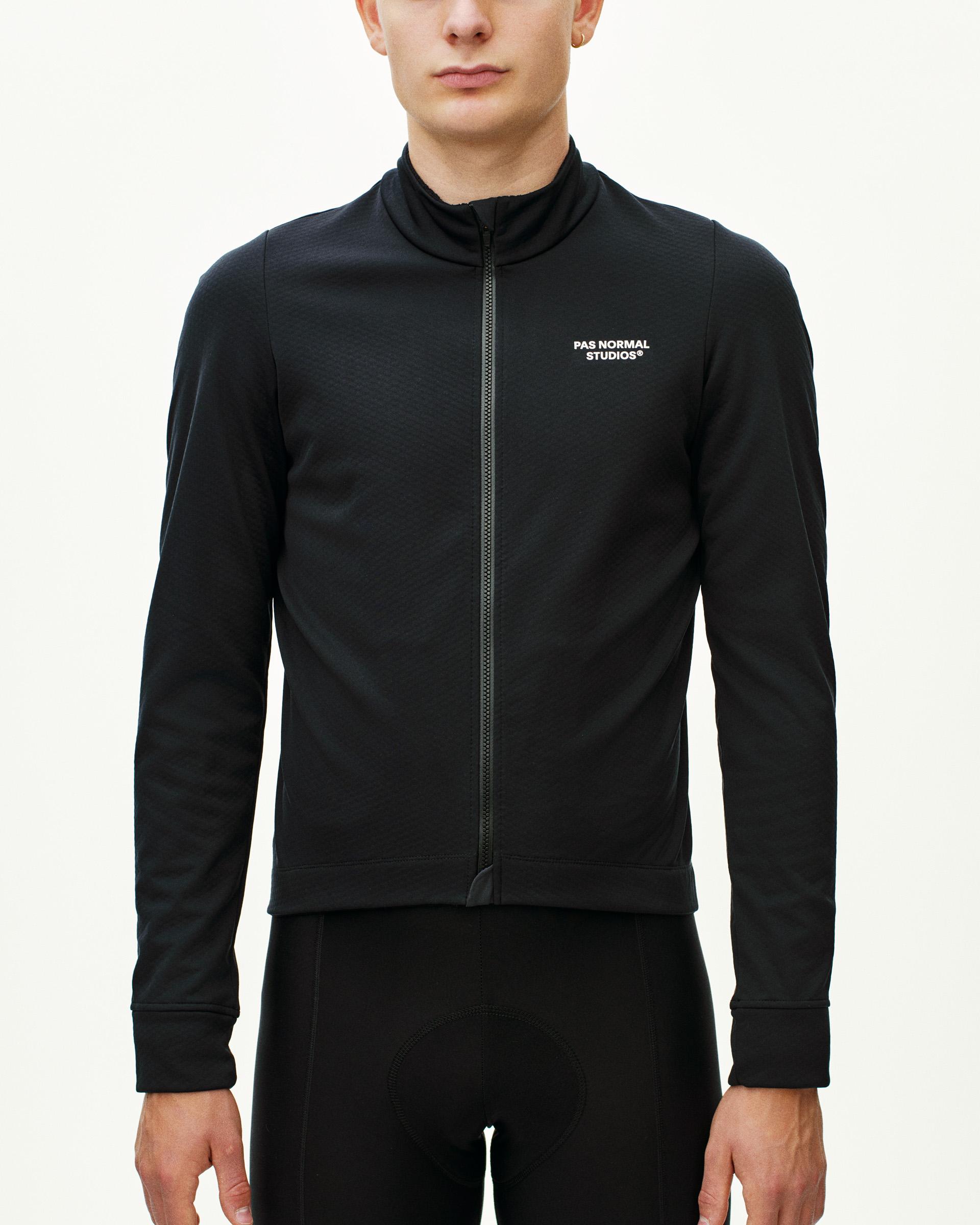 Black Essential Thermal long sleeve cycling jersey on model with full zip and white chest logo