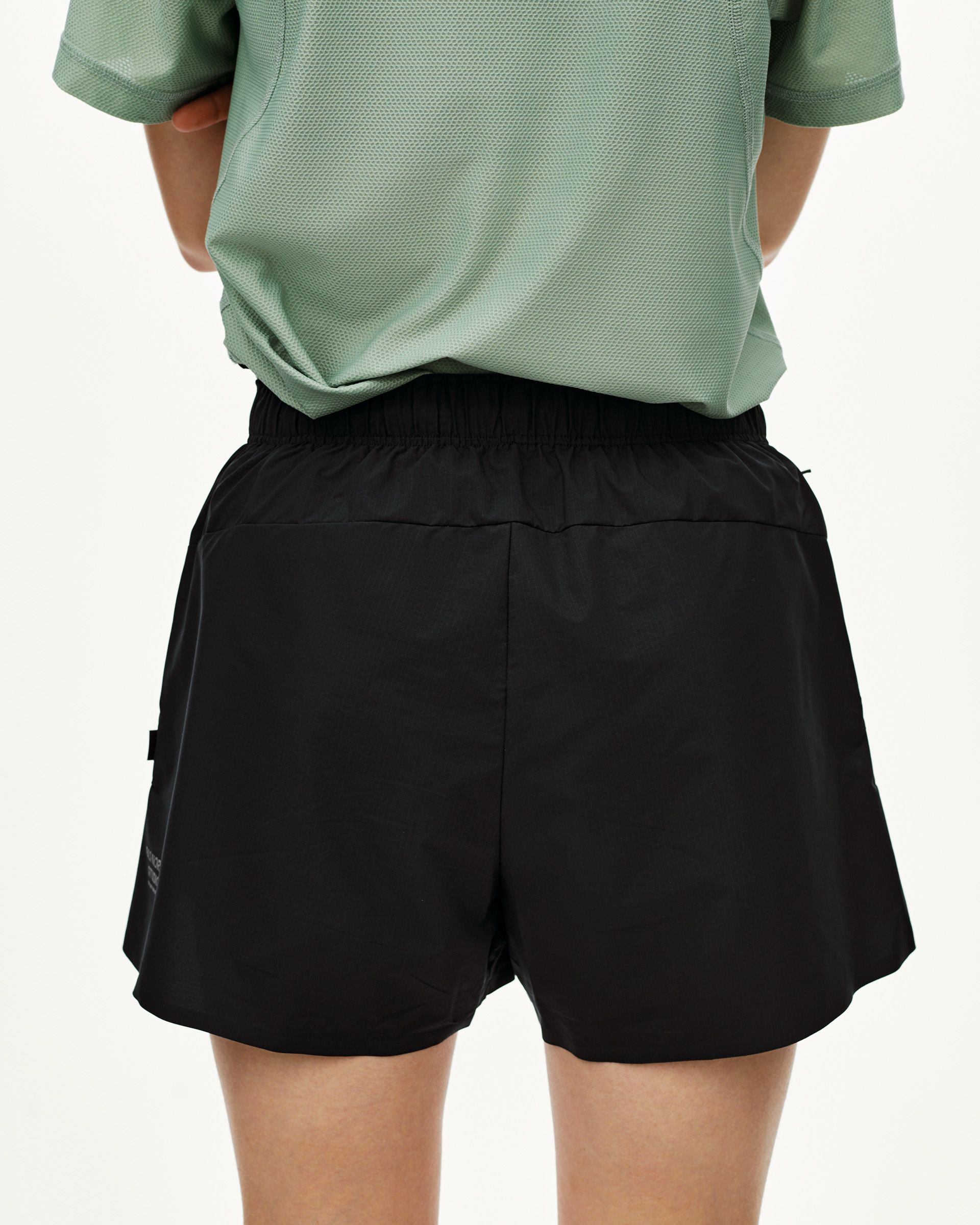 Black Balance women's shorts, rear view on model with elastic waistband and side pocket