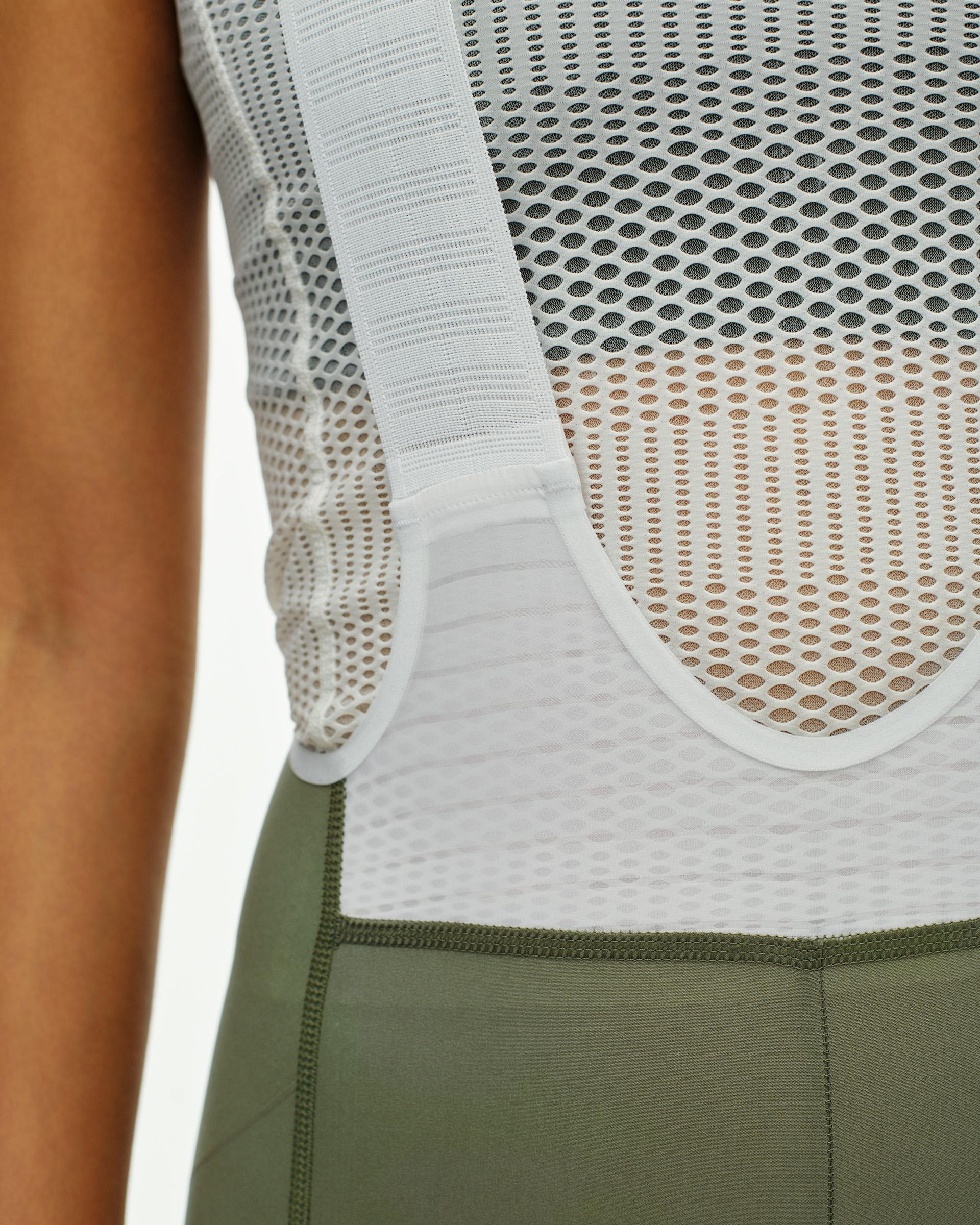 Grey PAS Mechanism Pro bibs on model showing white mesh upper and green lower panel
