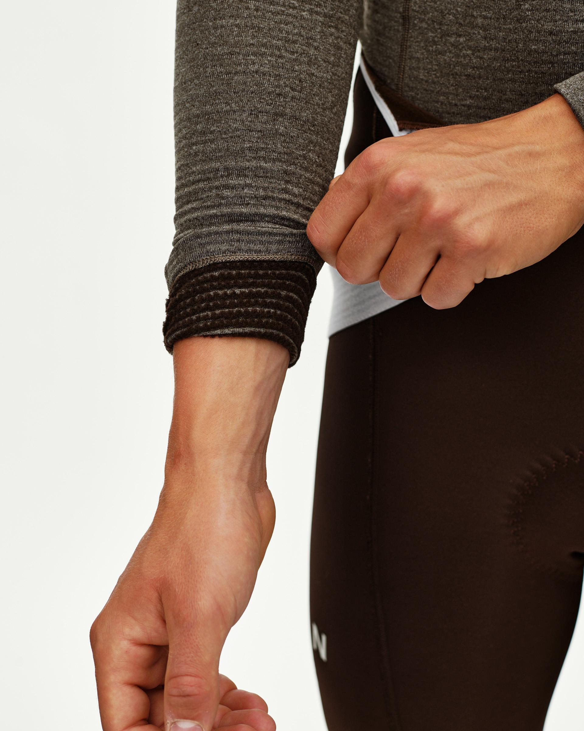 Dark Coffee brown Mechanism thermal long sleeve cycling base layer, detail view of ribbed cuff on model