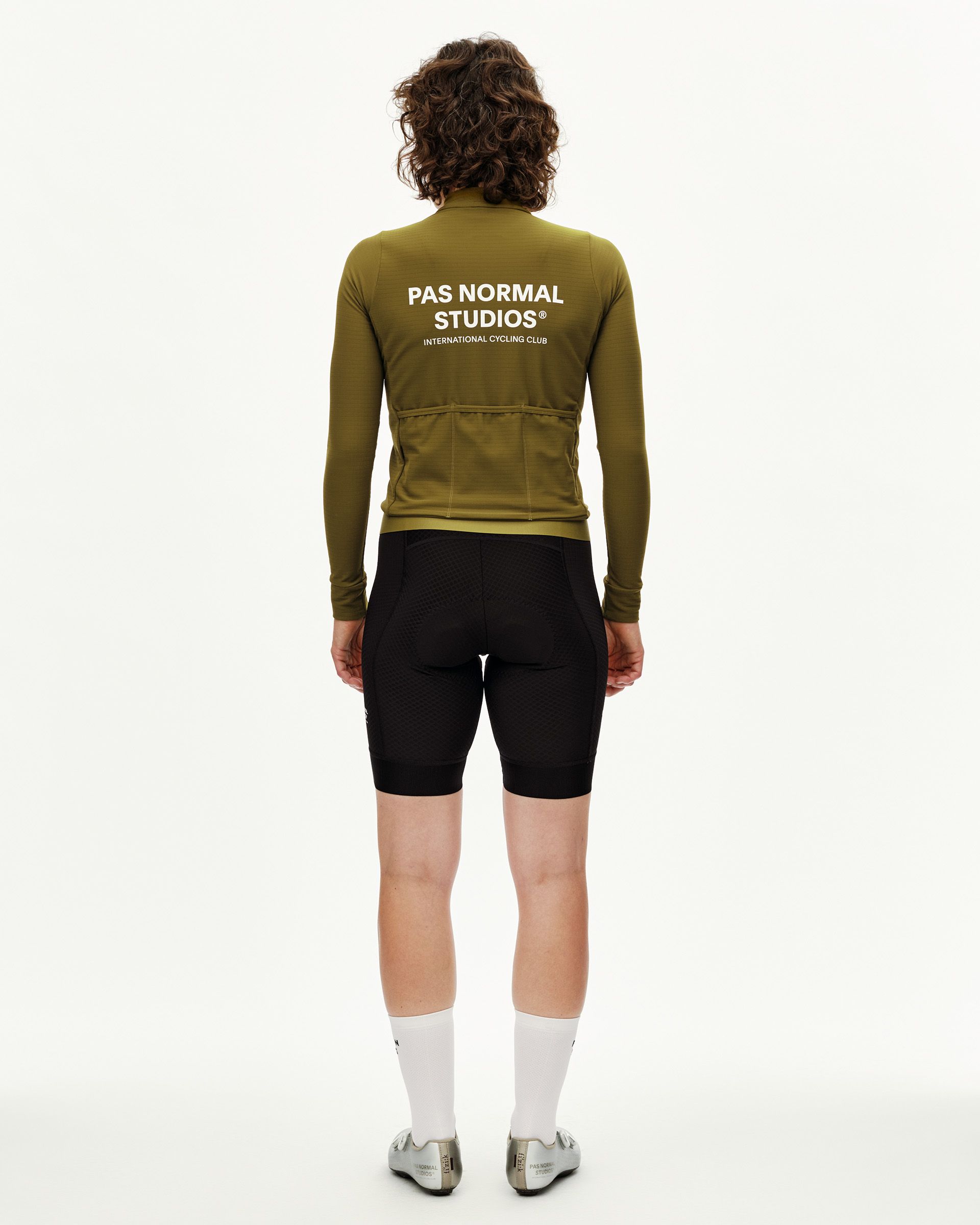Khaki Green Essential long sleeve cycling jersey on model, rear view with white back print