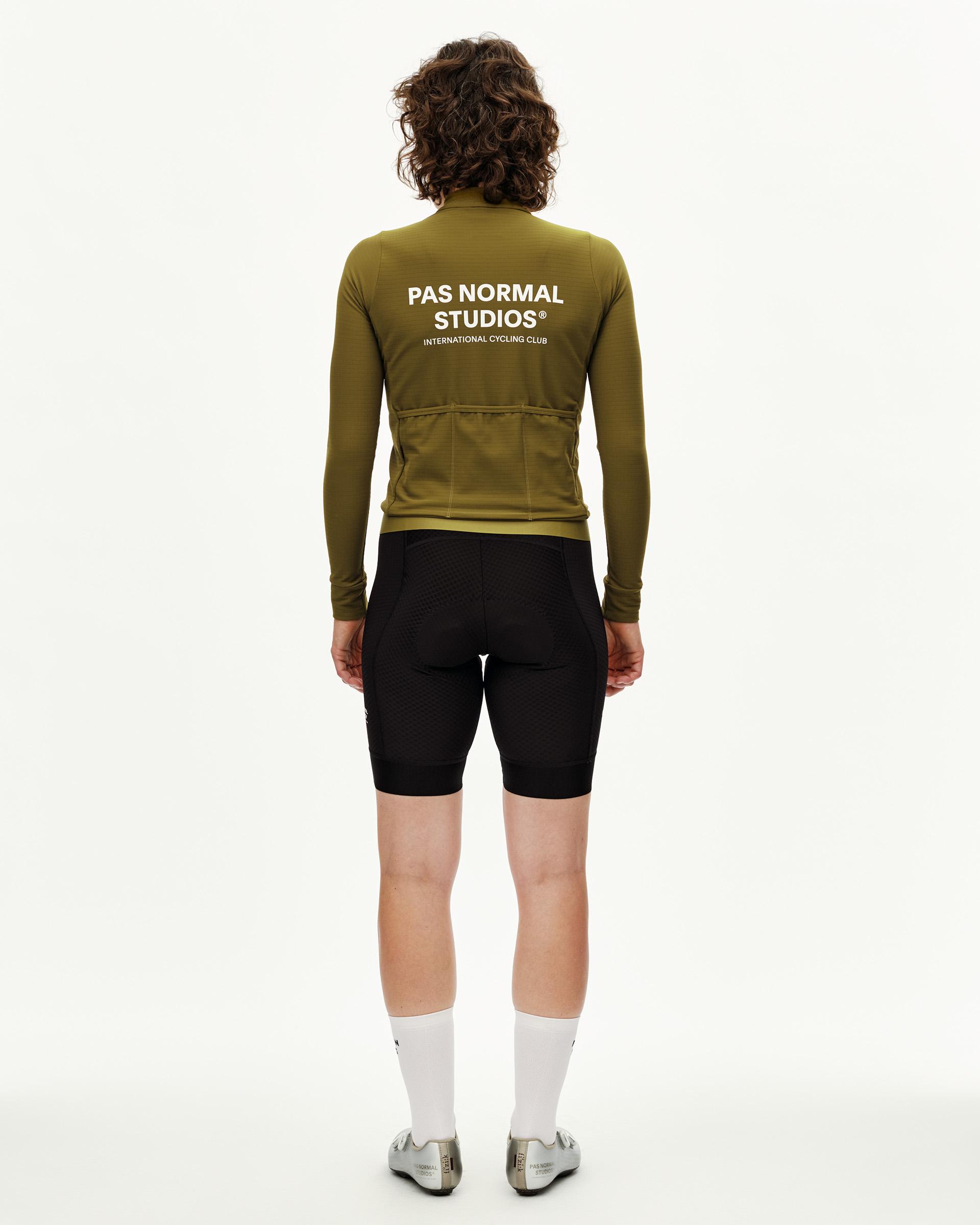 Khaki Green Essential long sleeve cycling jersey on model, rear view with white back print