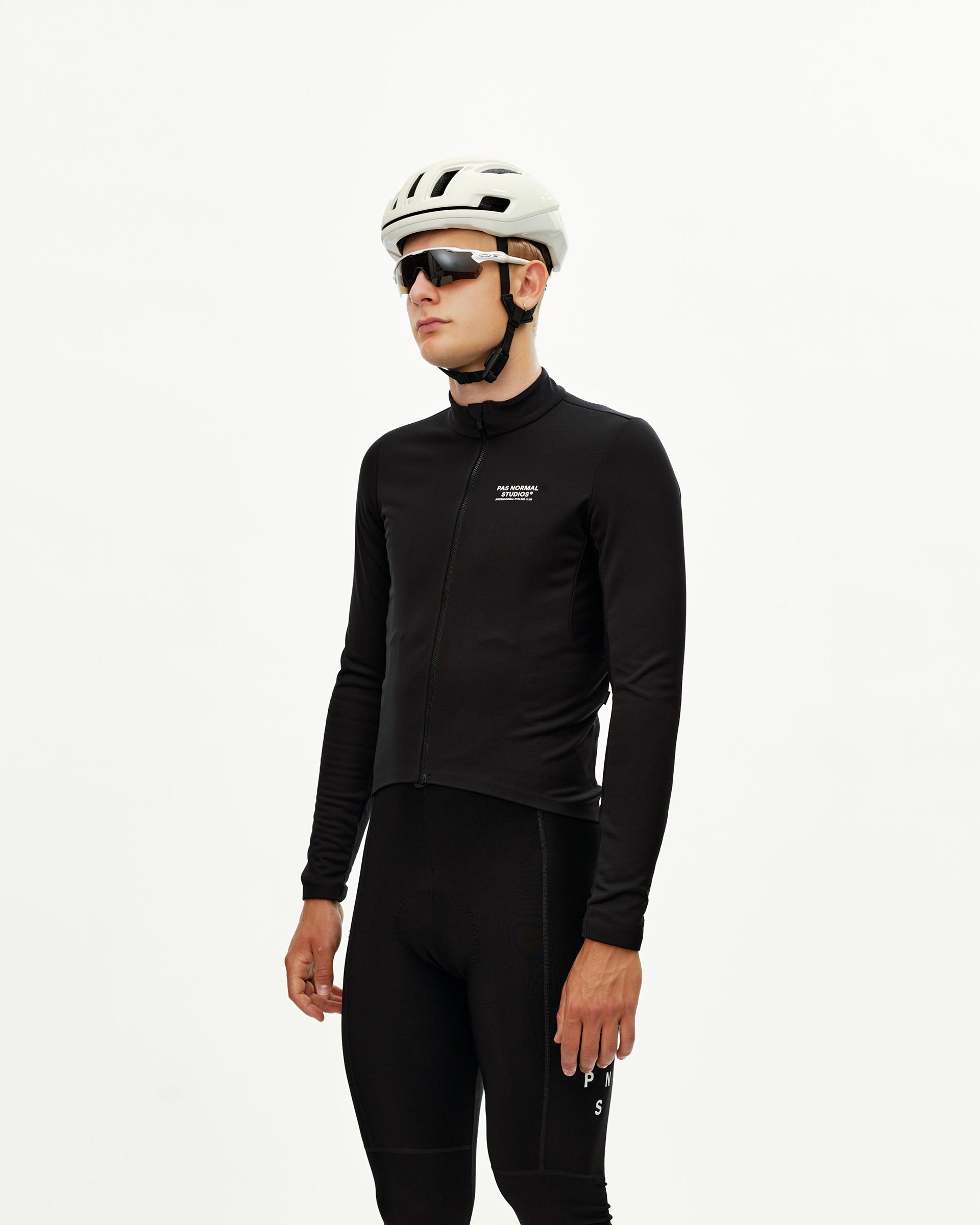 Black Mechanism Thermal Long Sleeve Jersey 2.0 cycling jersey on model, front view with white chest logo print