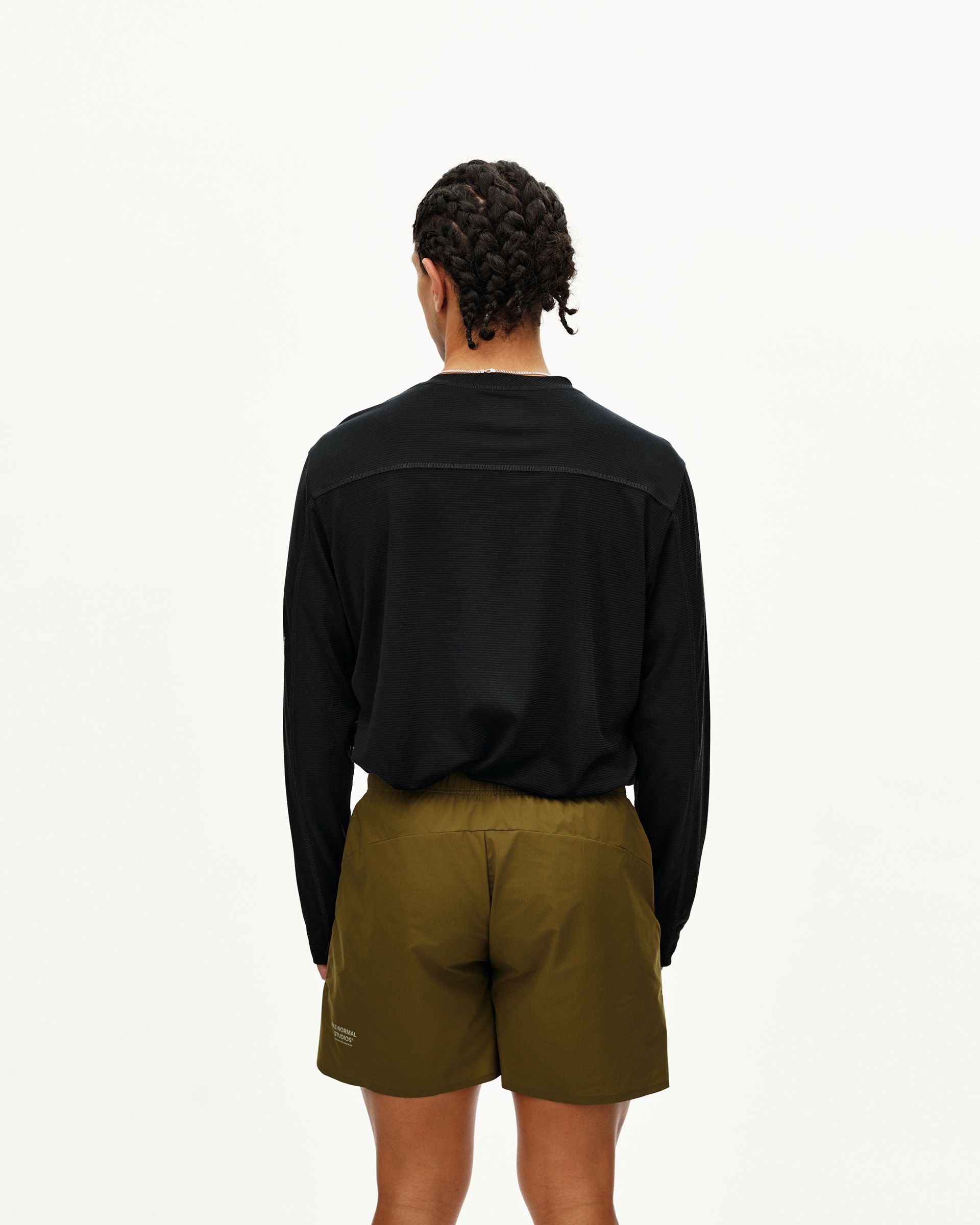 Black Balance long sleeve T-shirt on model, rear view with textured back panel and smooth shoulder yoke