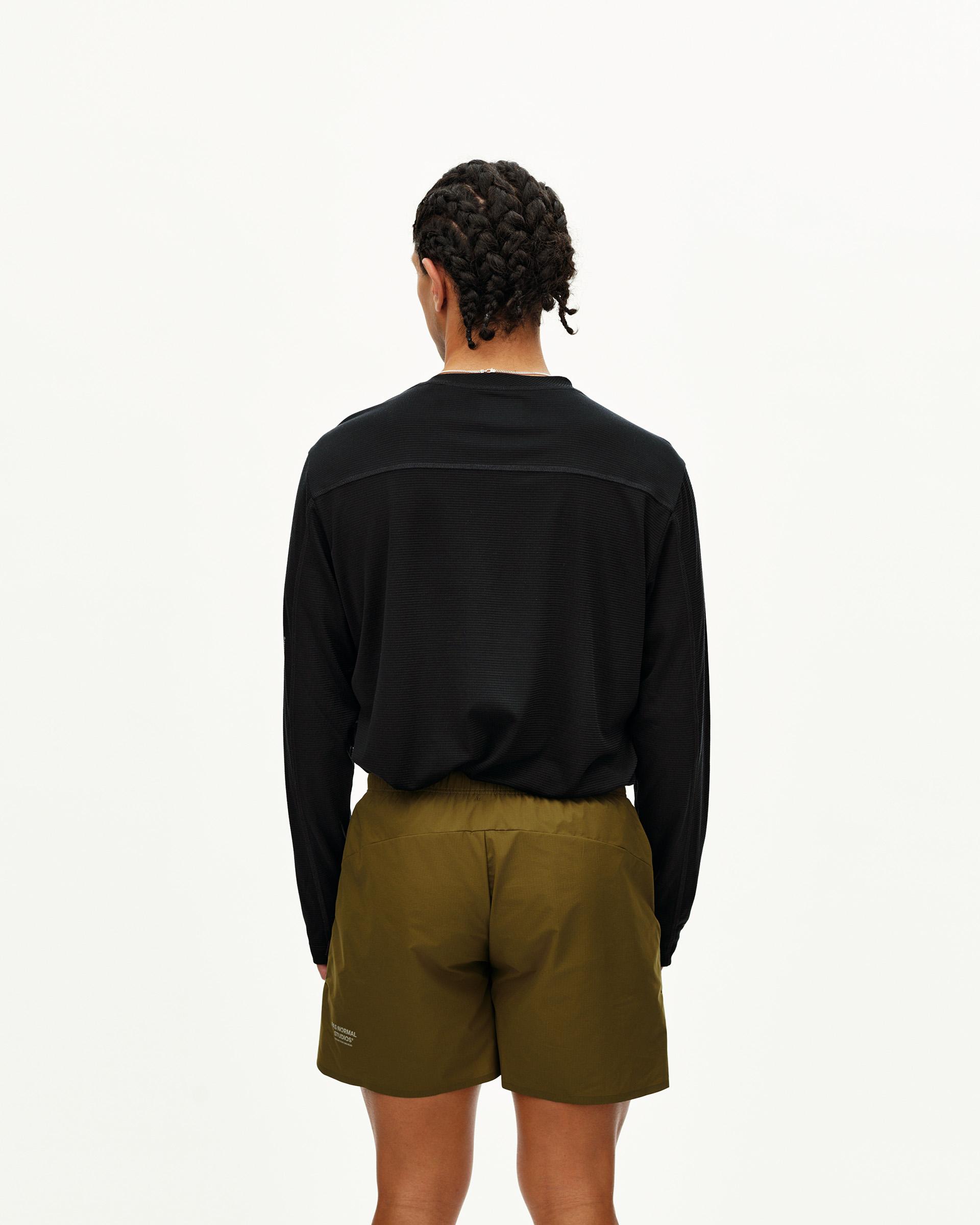 Black Balance long sleeve T-shirt on model, rear view with textured back panel and smooth shoulder yoke
