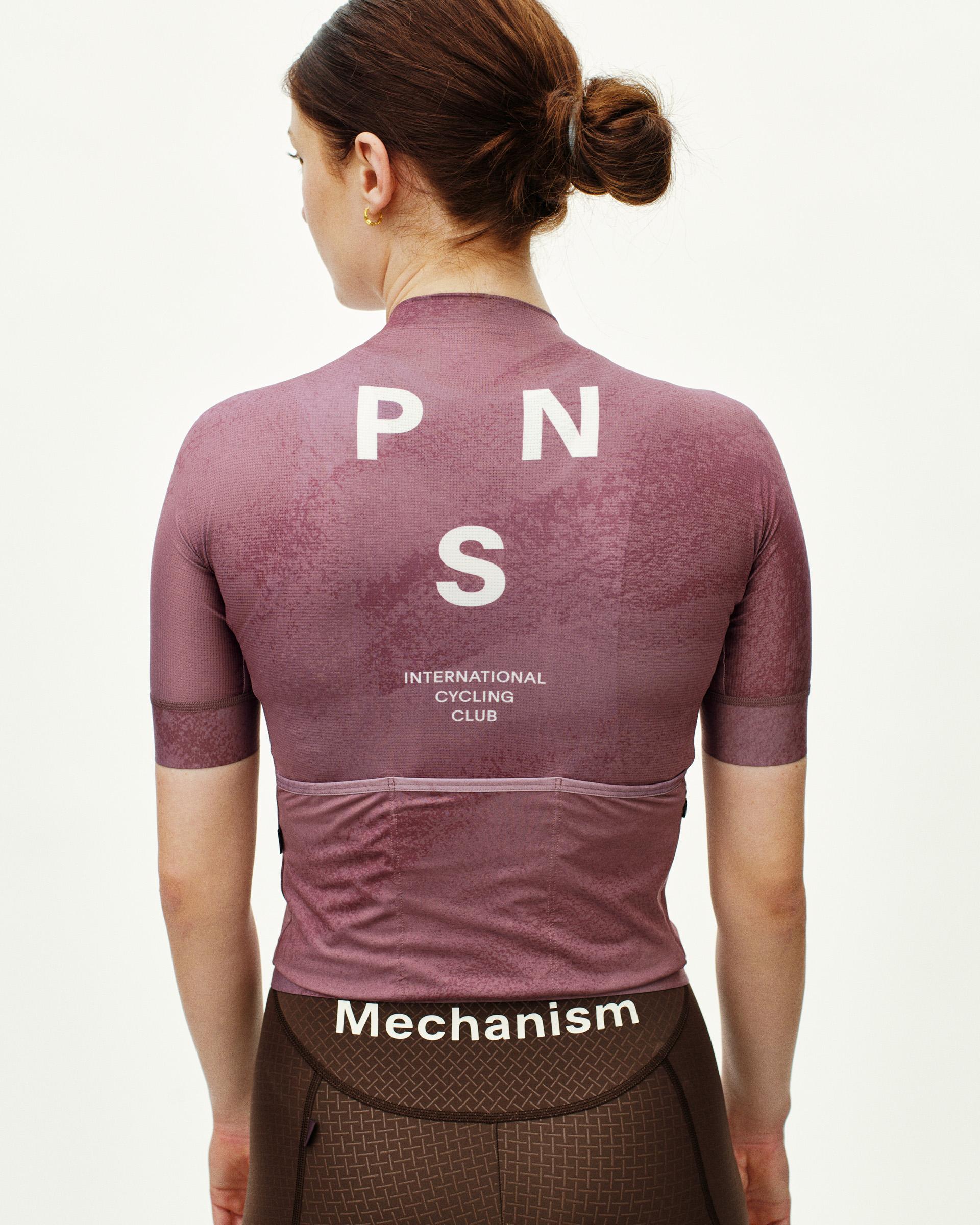 Purple Mechanism cycling jersey on model, rear view with white PNS logo and text print